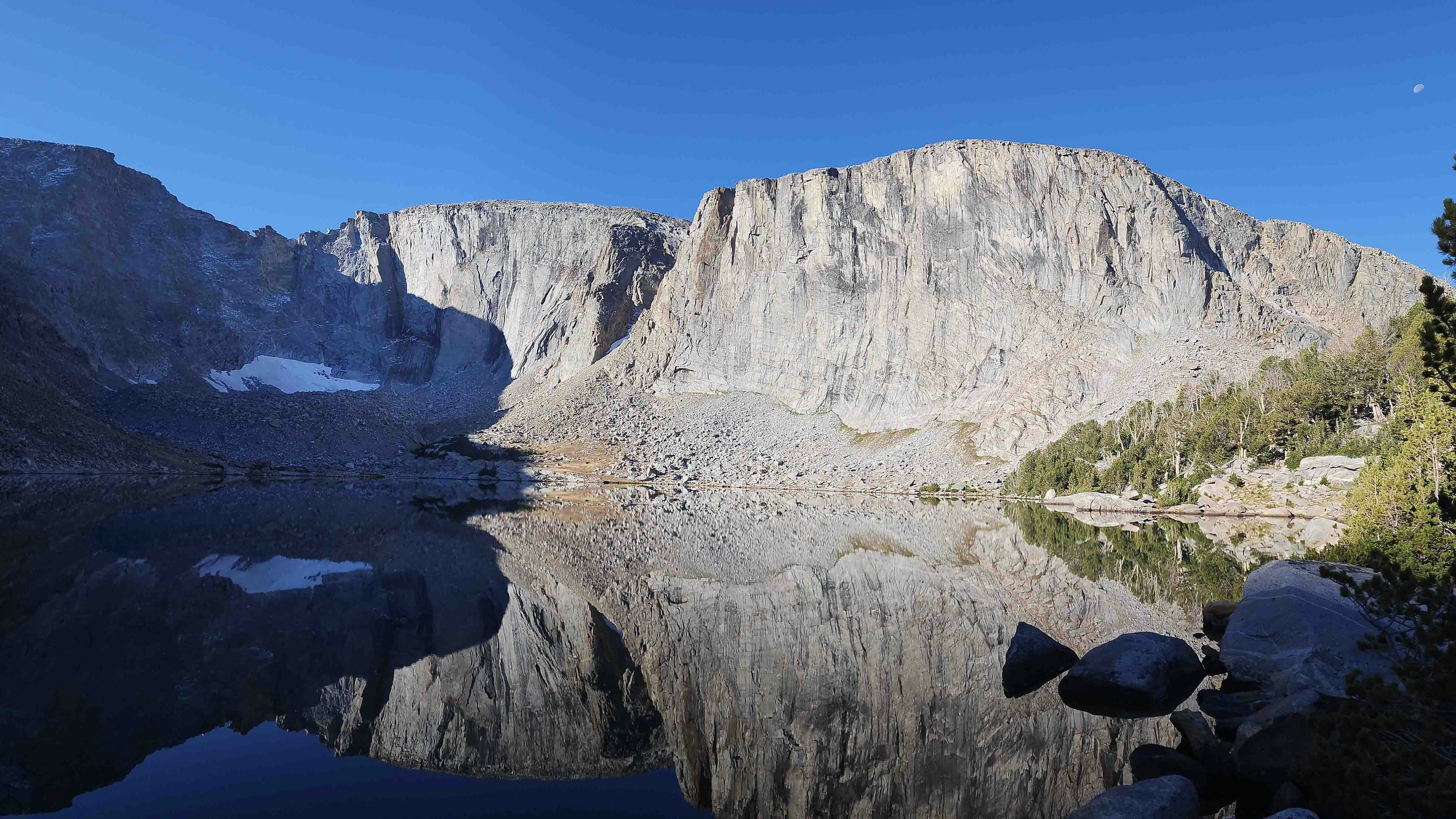 Just returned from backpacking in the Wind River Range. The mirror-like calmness of the water, the fresh dusting of snow and waning moon really made this sunrise on Leg Lake special!