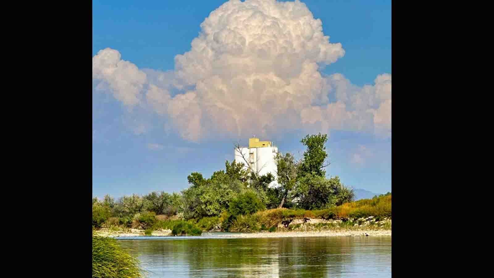 Cumulus clouds building with Worland sugar factory silo in foreground on Sept 21, 2023