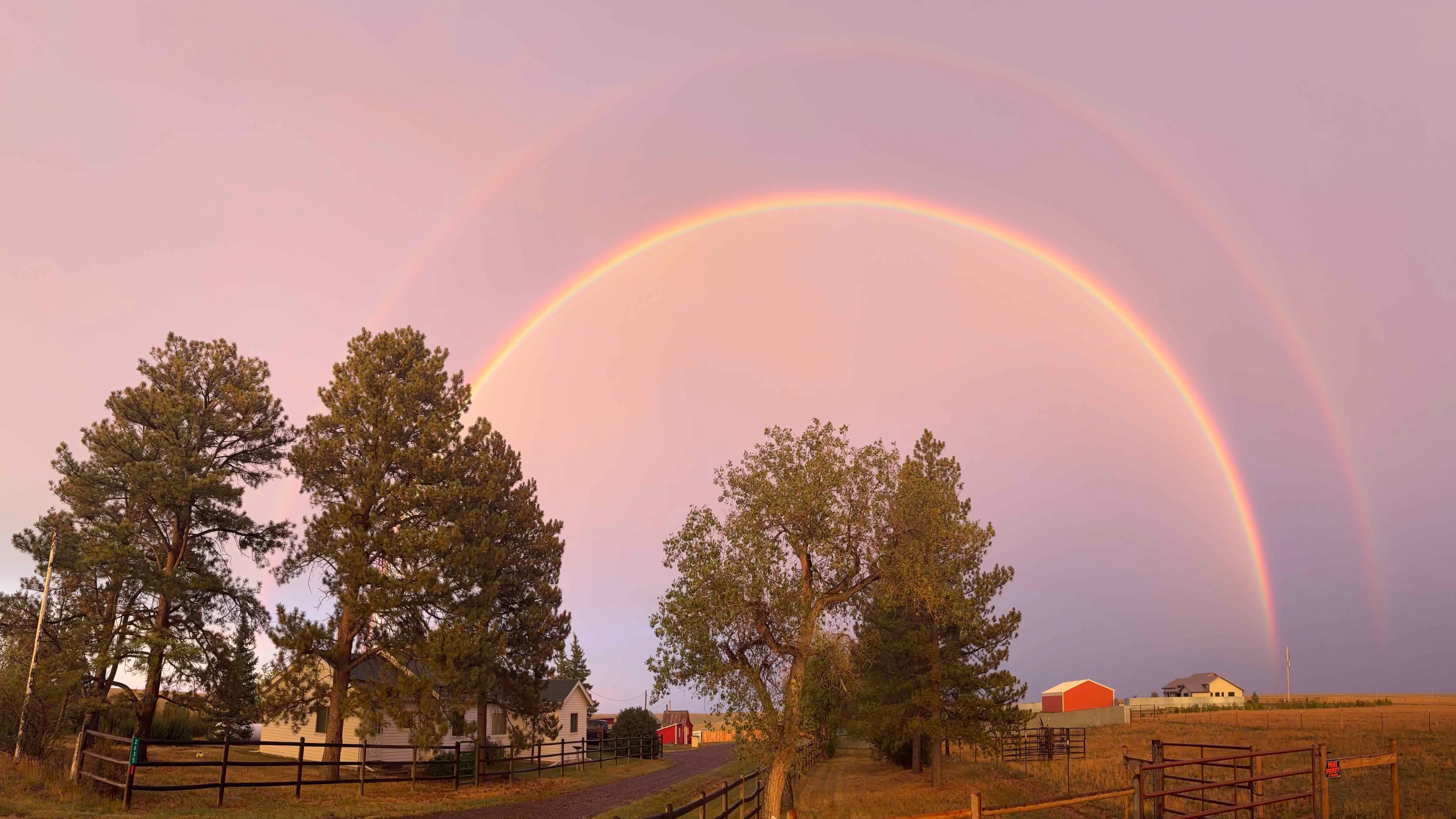 "An eye catching high arched double rainbow encasing all of our homes, including the homestead."