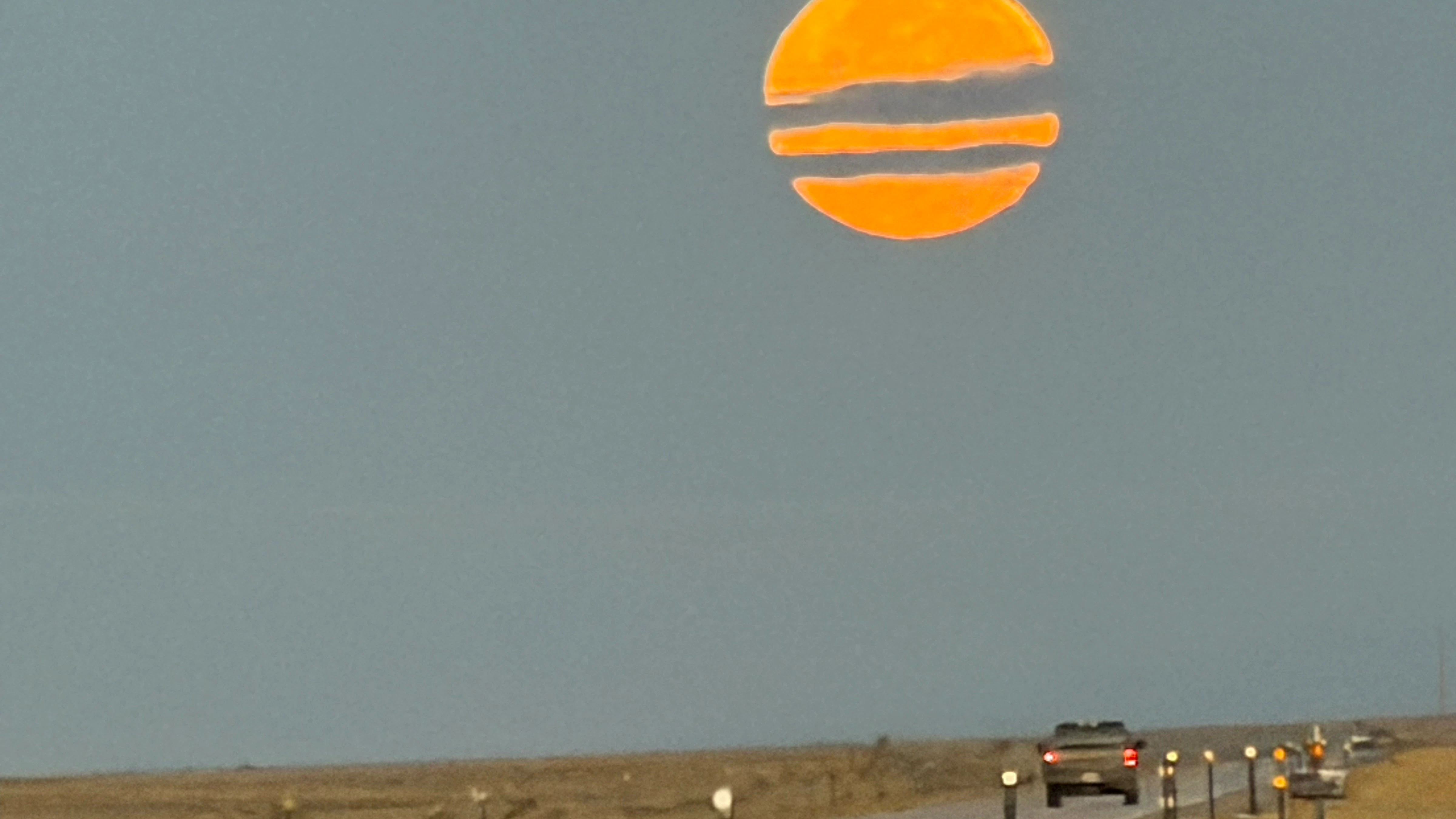 Pumpkin-looking moon dropping at sunrise Saturday near Jeffrey City.