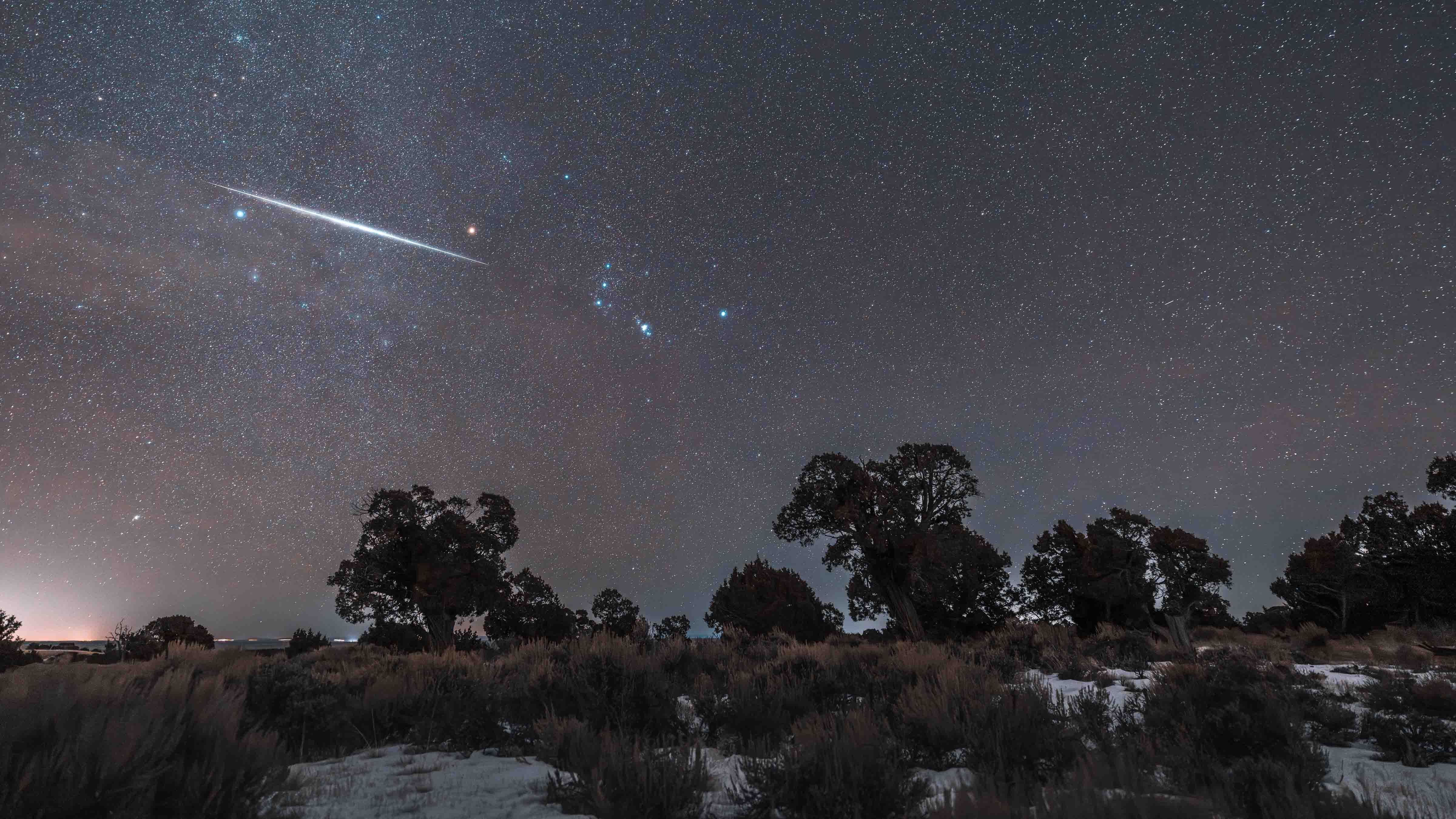 "A very thin layer of cloud amplified the constellation Orion and the meteor flash is almost directly in line with the Orion's sword. I took the photo near Carter, Wyoming."