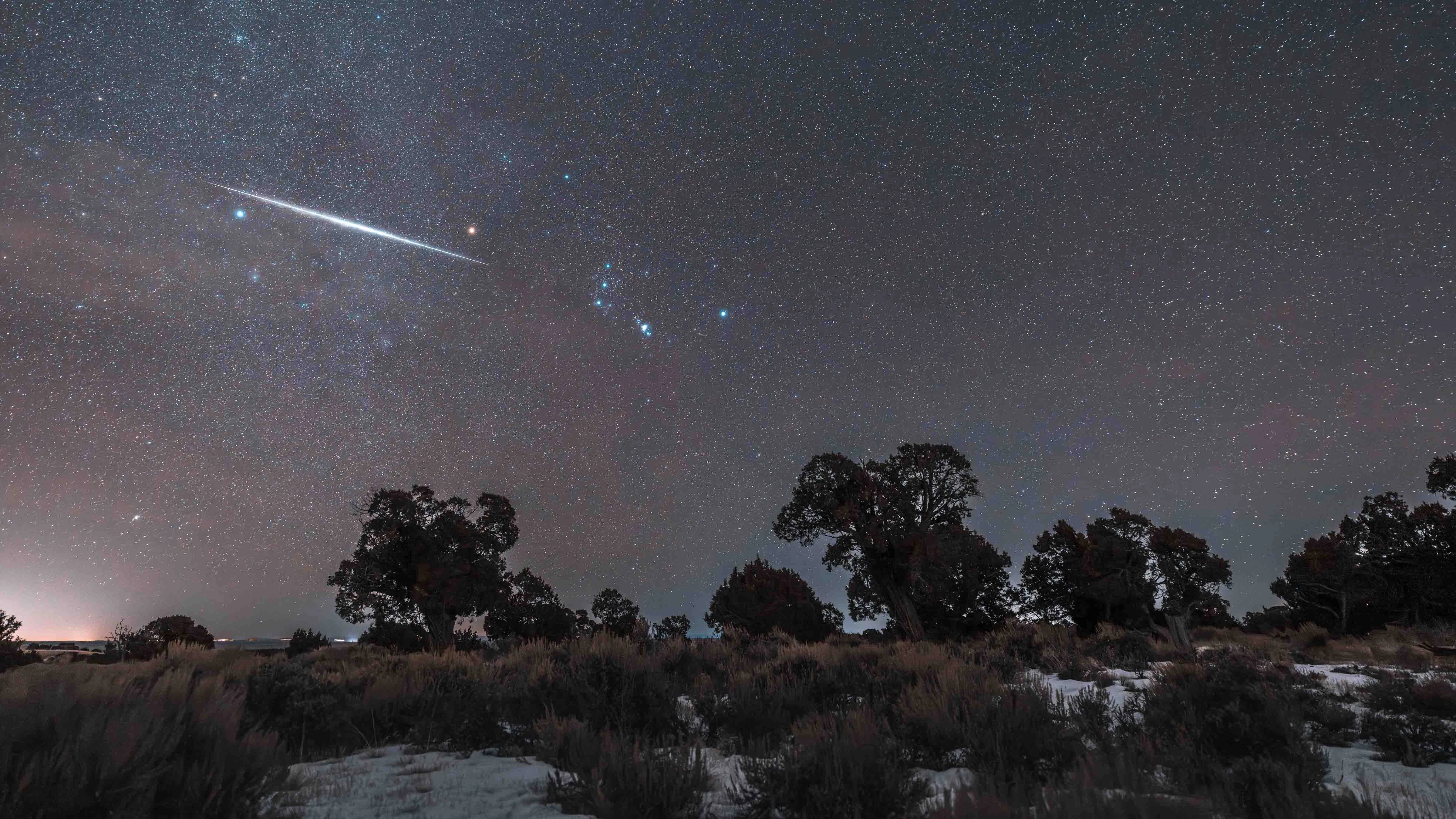 "A very thin layer of cloud amplified the constellation Orion and the meteor flash is almost directly in line with the Orion's sword. I took the photo near Carter, Wyoming."