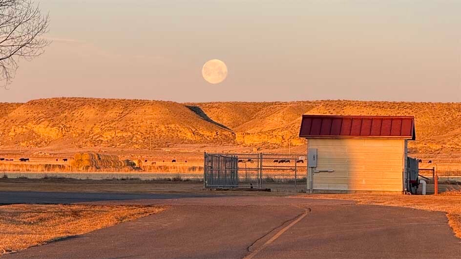 "Moon setting behind a hill taken at the Wyoming Boys School in Worland, Wyoming."