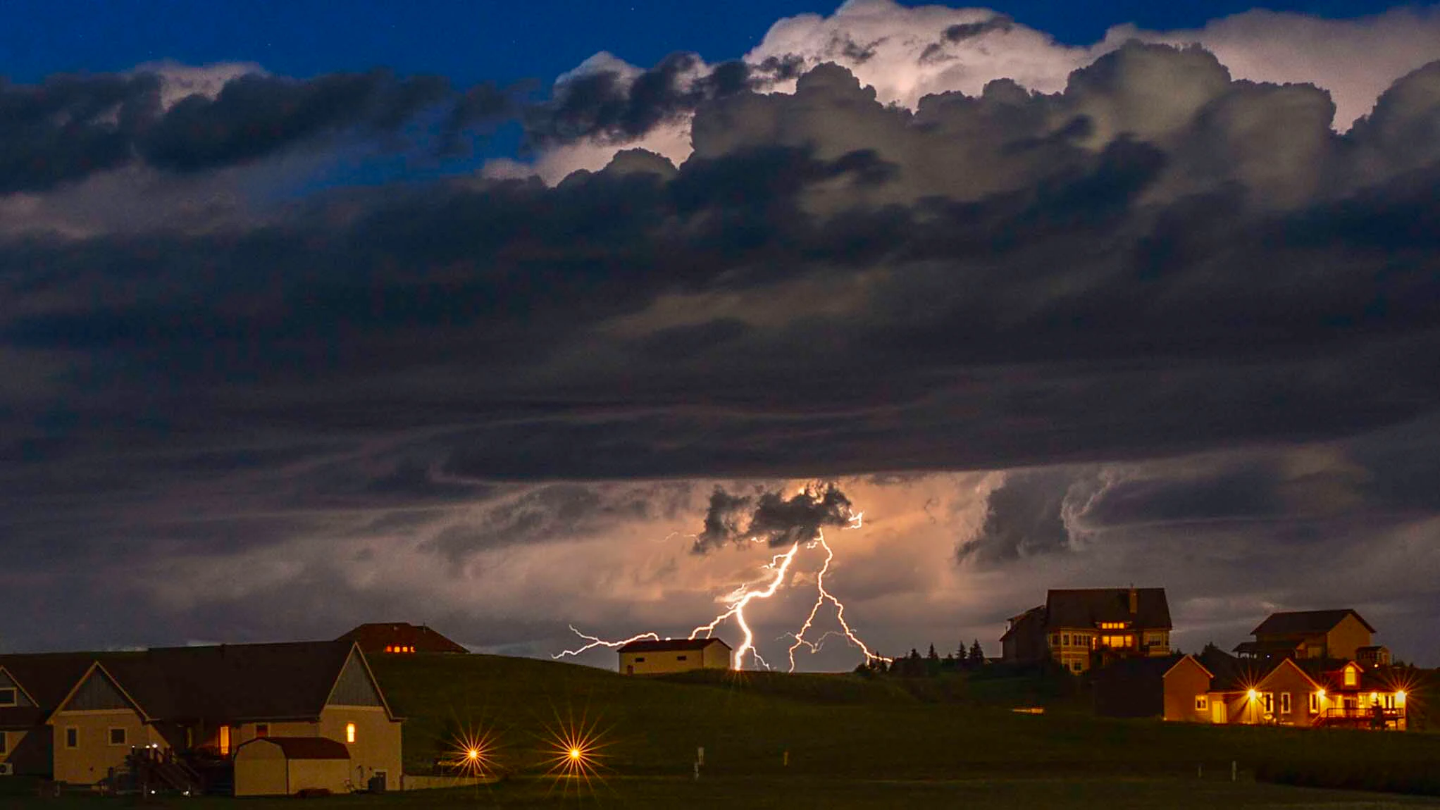 "Bolt of the day. Near full moon illuminates the sky. Storm was about 35 miles away."