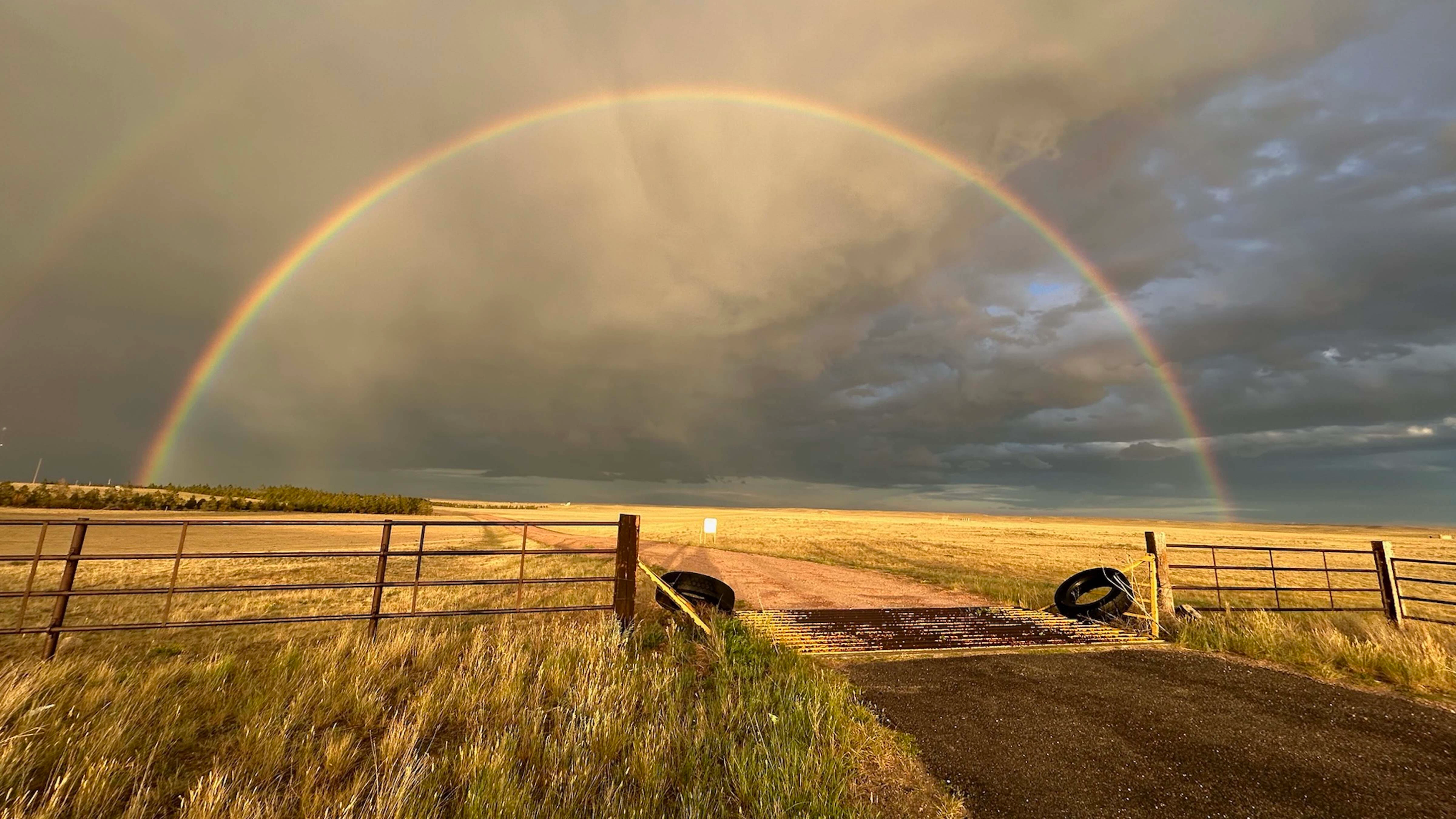 "Rainbow at sunset over ranchland just east of Cheyenne."