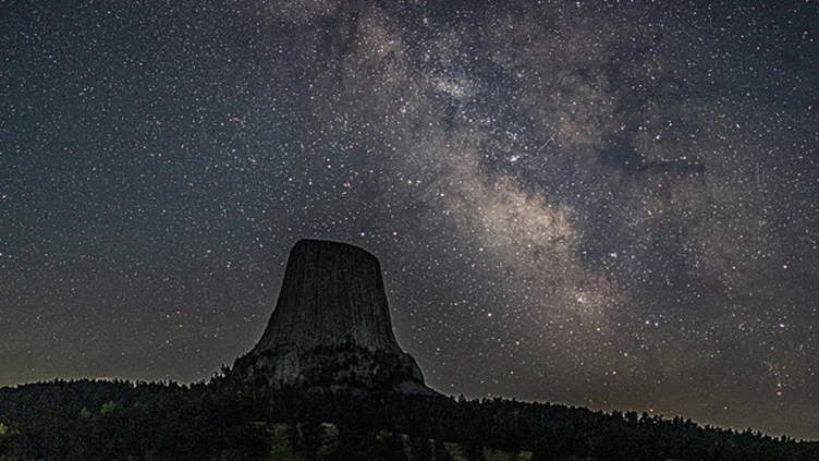 The Milky Way reaches its peak each July over Devils Tower. This July, the nighttime display included faint northern lights over the Tower in conjunction with the Milky Way.