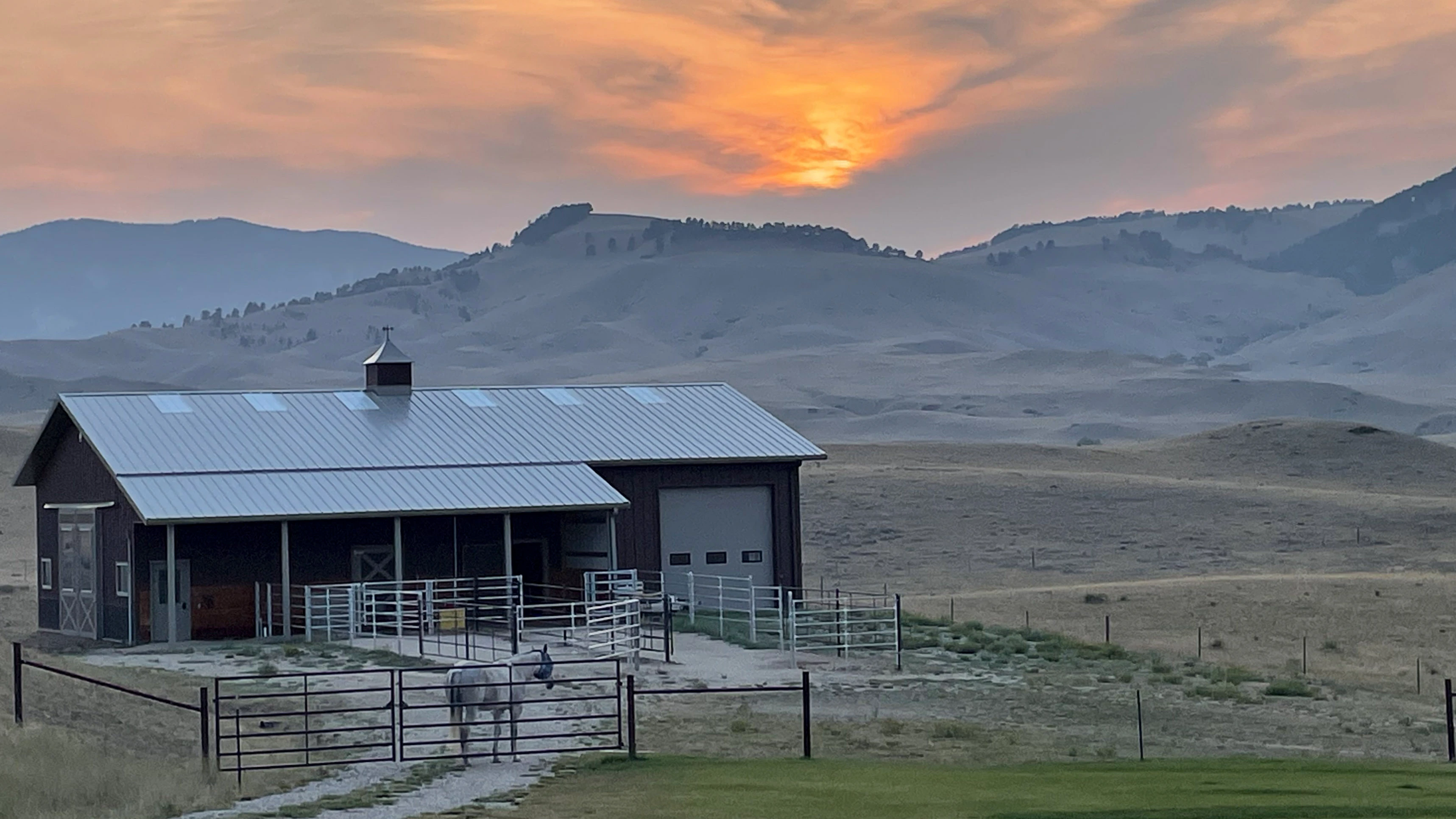 Smokey skies can result in some good photos. Sunset on August 11 southwest of Buffalo. And my horse, Smokey, really that's his name, is in the foreground.