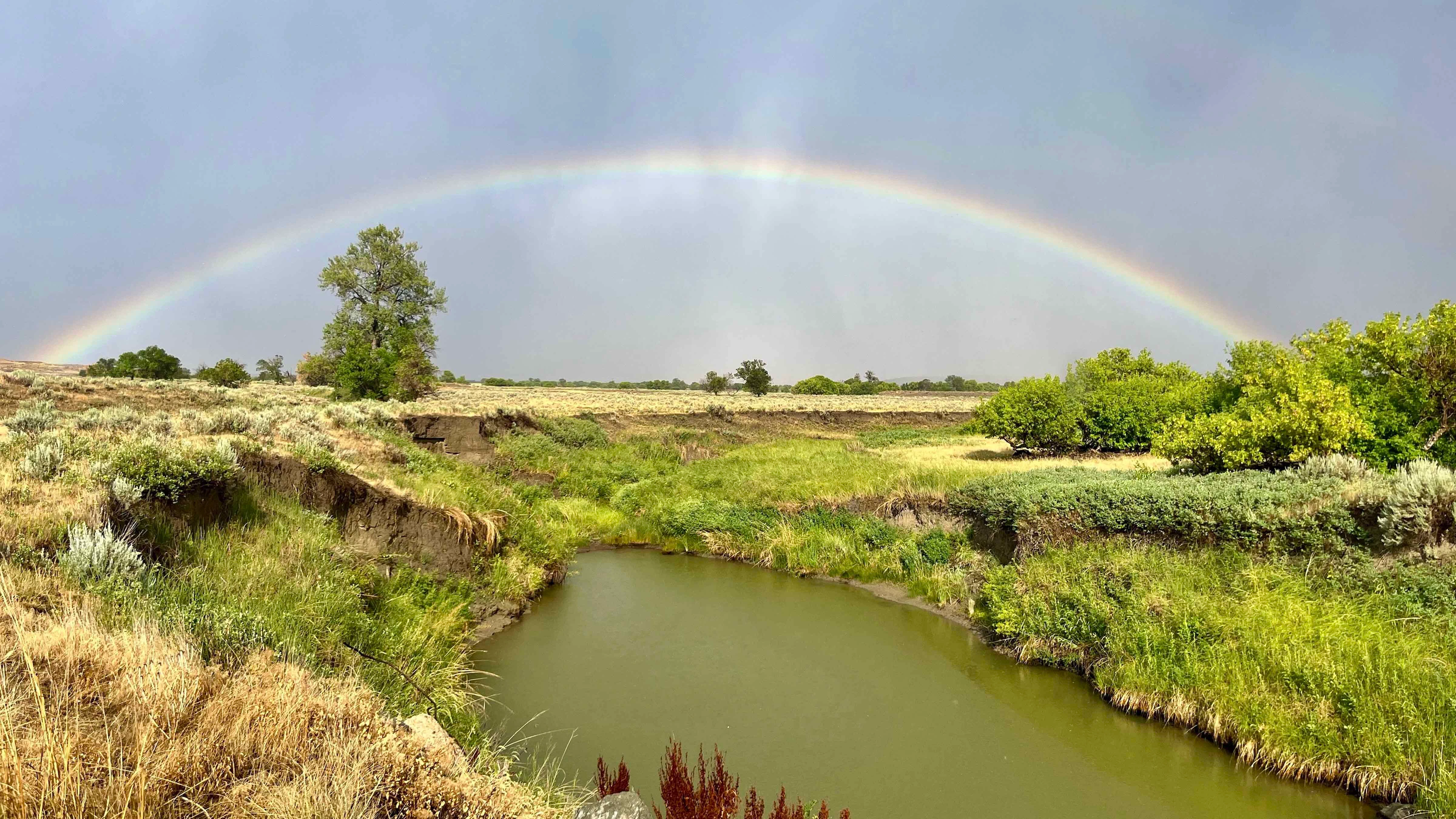 "Beautiful rainbow stretched over the Little Missouri River near Hulett as welcome rainclouds gathered on the horizon."