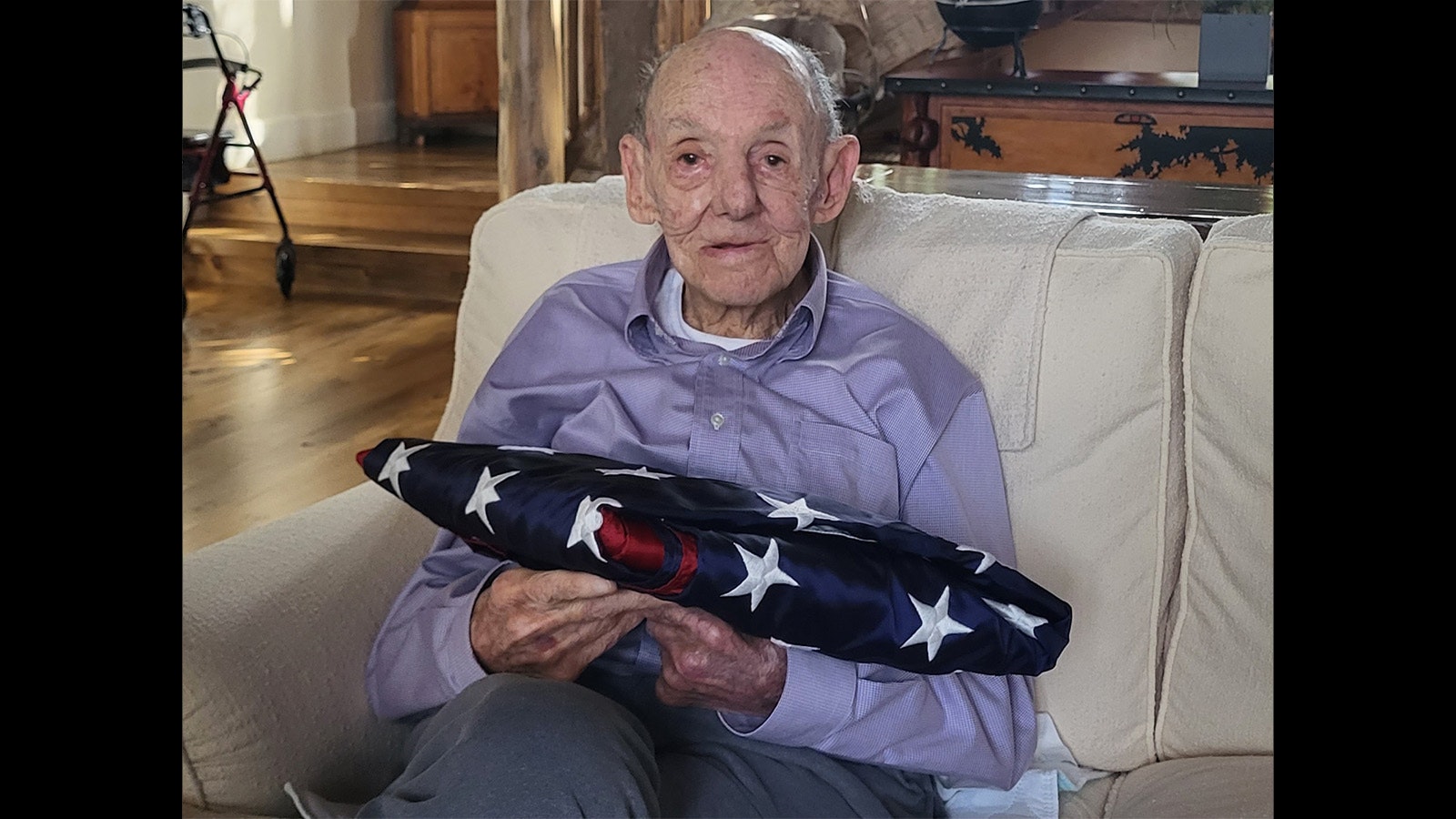 Donald Siegel with a flag that was flown over the U.S. Capitol in his honor for his service during World War II.