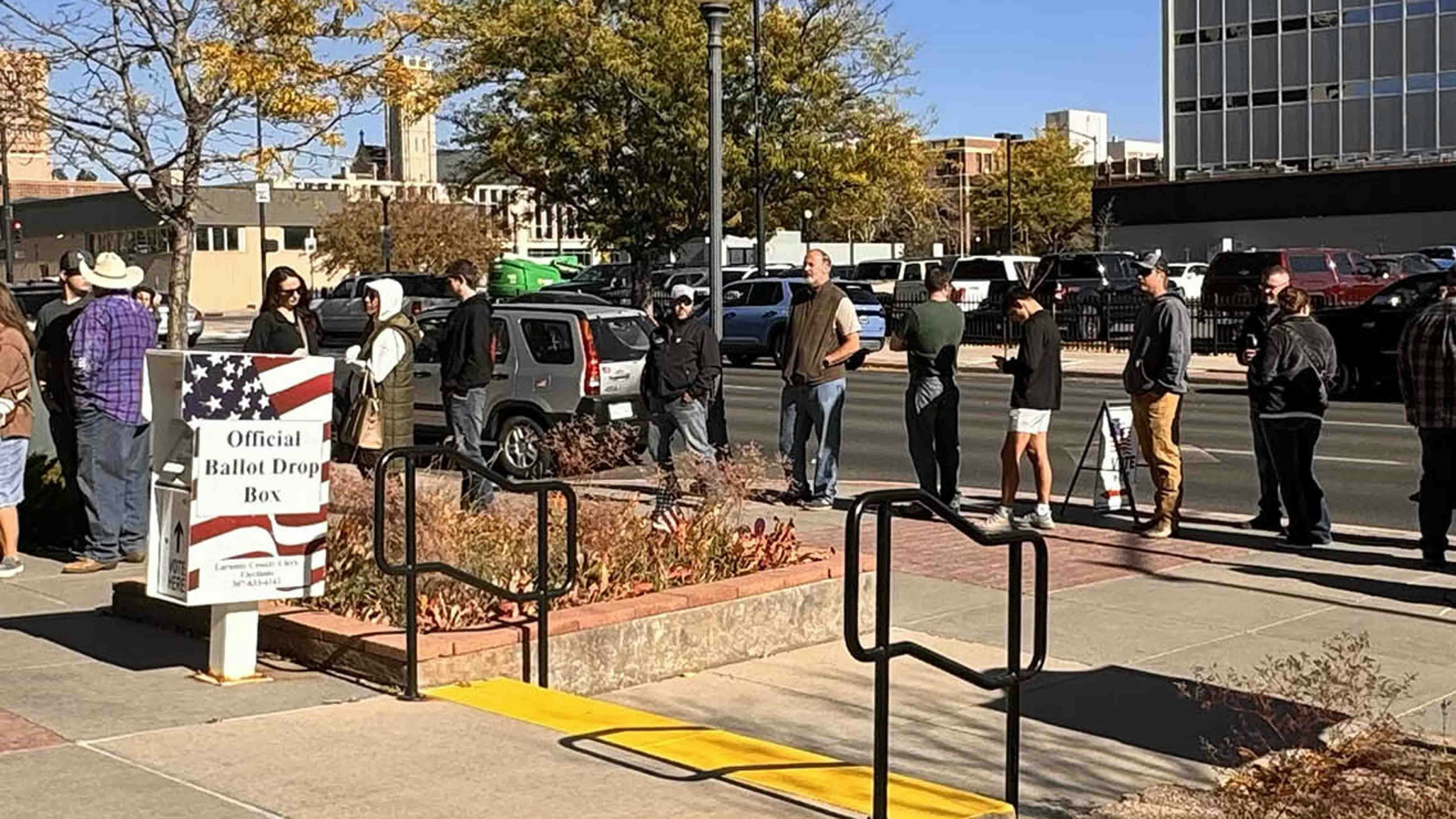 Voting line in Laramie County with prominent ballot drop box in foreground. (FILE PHOTO)