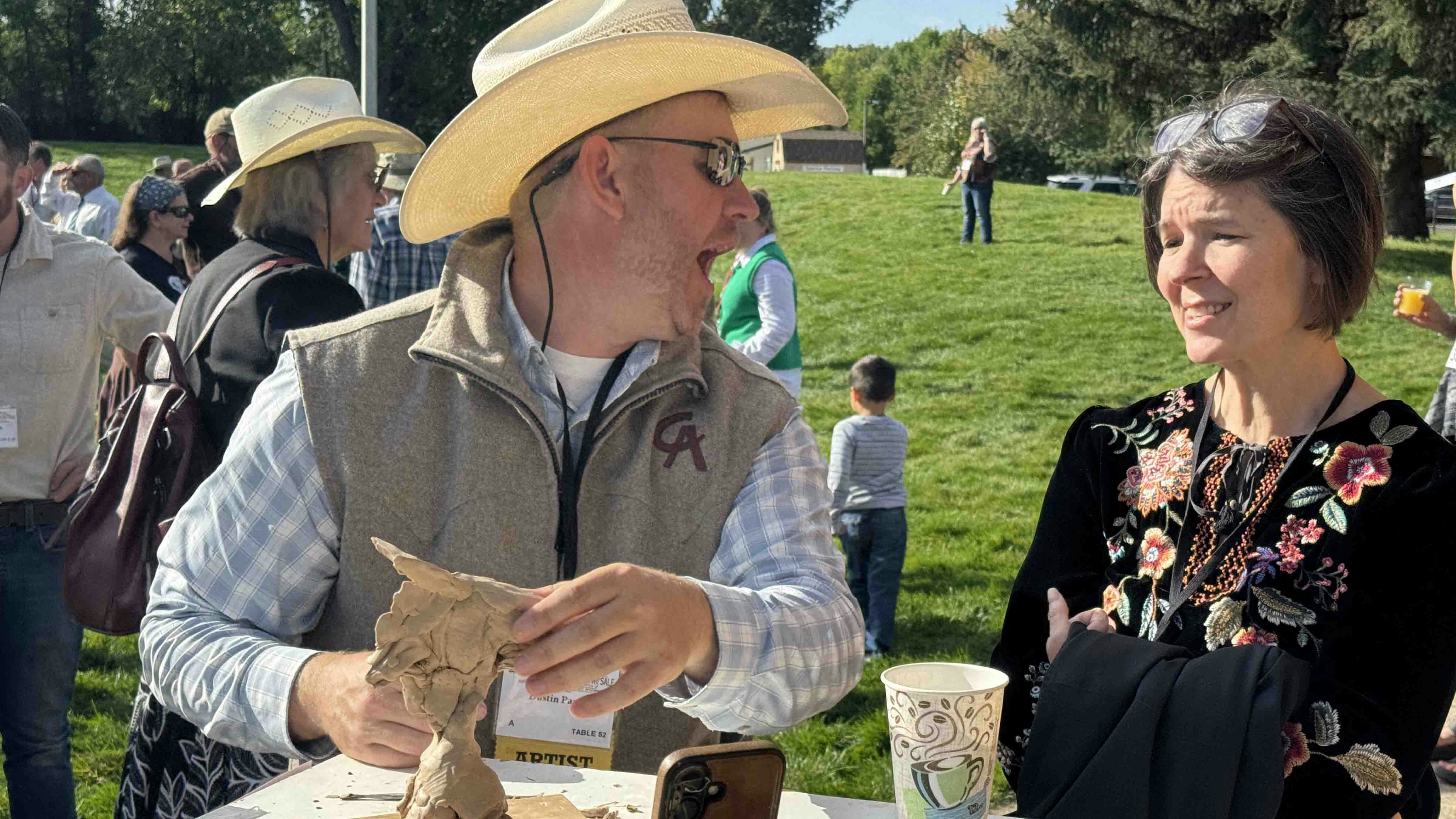 Dustin Payne chats with a patron while sculpting "My Dad Was an Ass" during the 44th Buffalo Bill Art Show and Sale's Saturday morning Quick Draw. He sold over 15 editions of this soon-to-be bronze sculpture for $1,200 each, bringing in over $18,000.