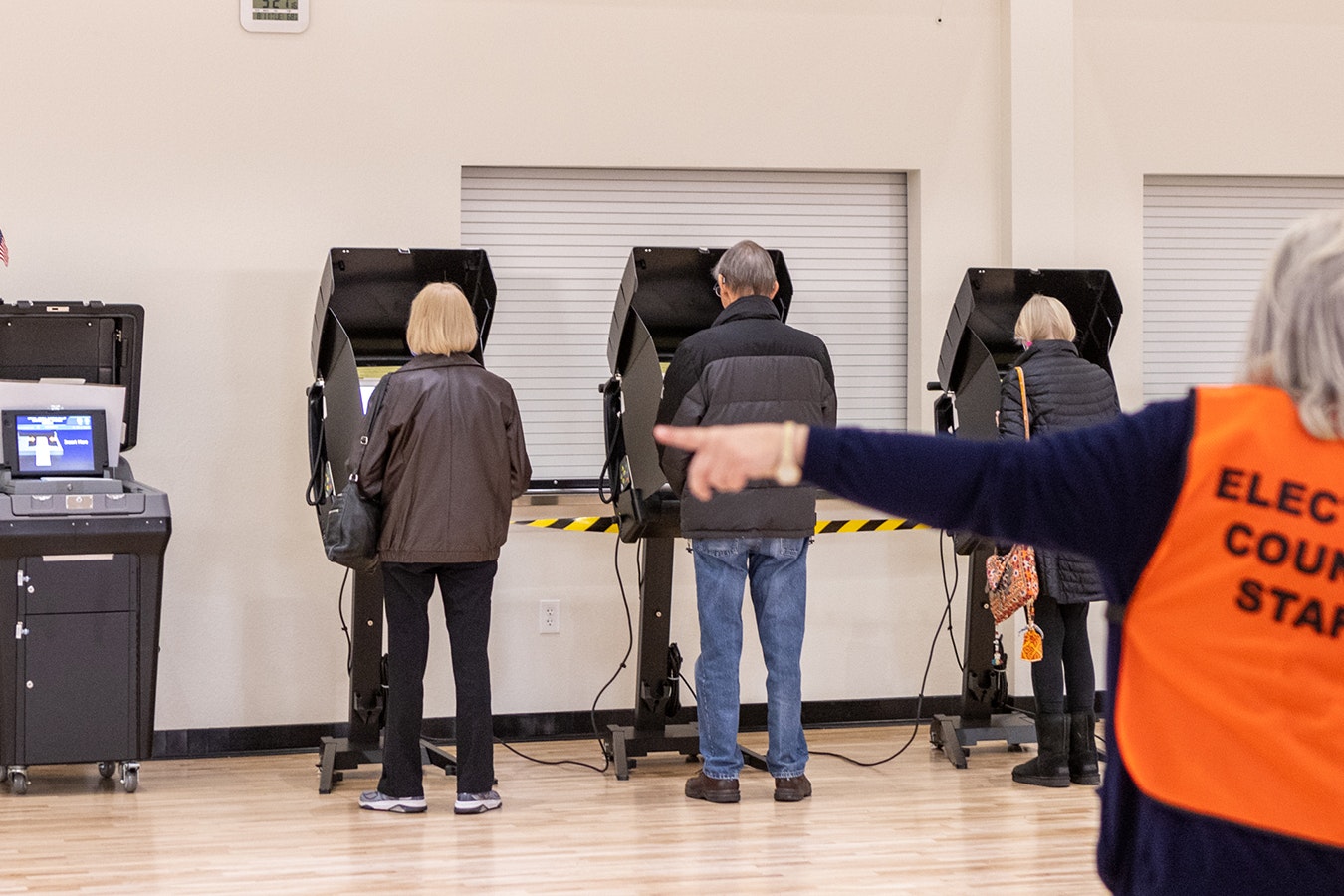 A Laramie County elections staffer directs voters during the 2022 general election in Cheyenne.
