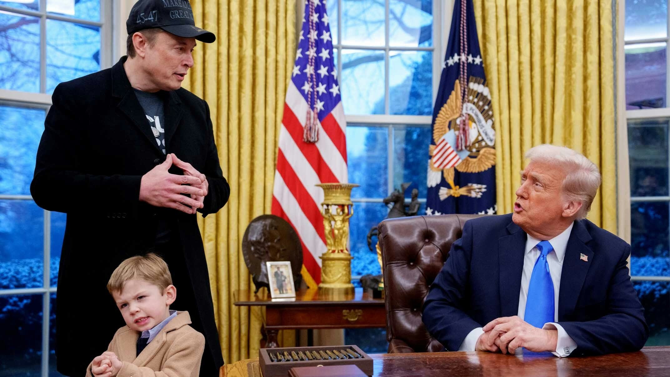 U.S. President Donald Trump is joined by Tesla and SpaceX CEO Elon Musk, and his son, X Musk, during an executive order signing in the Oval Office at the White House on February 11, 2025