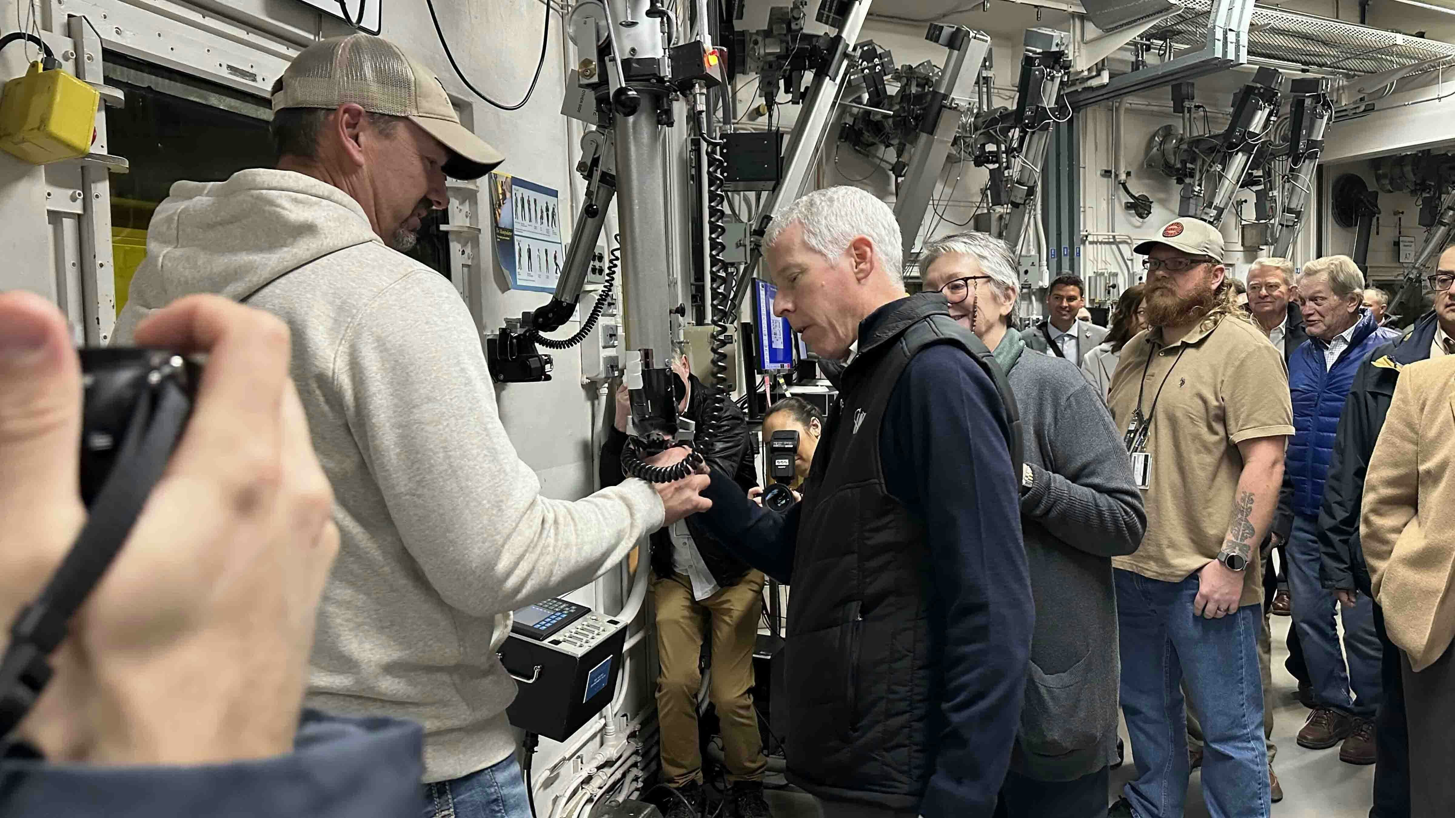 Energy Secretary Chris Wright got some hands-on experience at the Fuel Conditioning Facility at Idaho National Laboratory. The facility features two heavily shielded hot cells with remotely operated manipulators, allowing technicians to safely handle radioactive materials from behind five-foot-thick shielding walls while supporting expanded fuel cycle research and development.