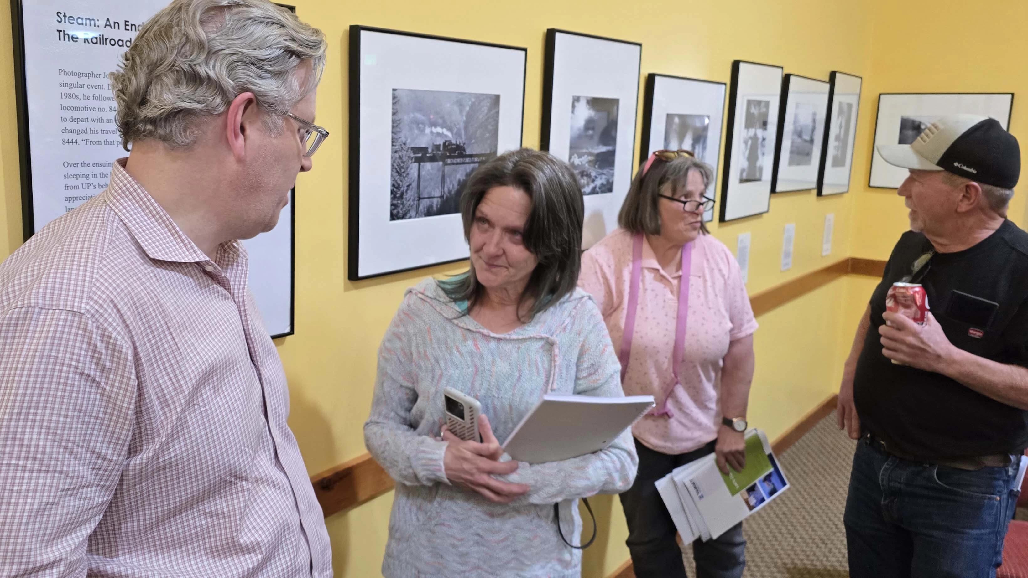 Trenton Thornock, left, talks to a resident about her hunting concerns in Wyoming after a public engagement forum Prometheus Hyperscale held in Evanston to talk about its proposed 1.5 gigawatt data center on Thornock's family ranch.
