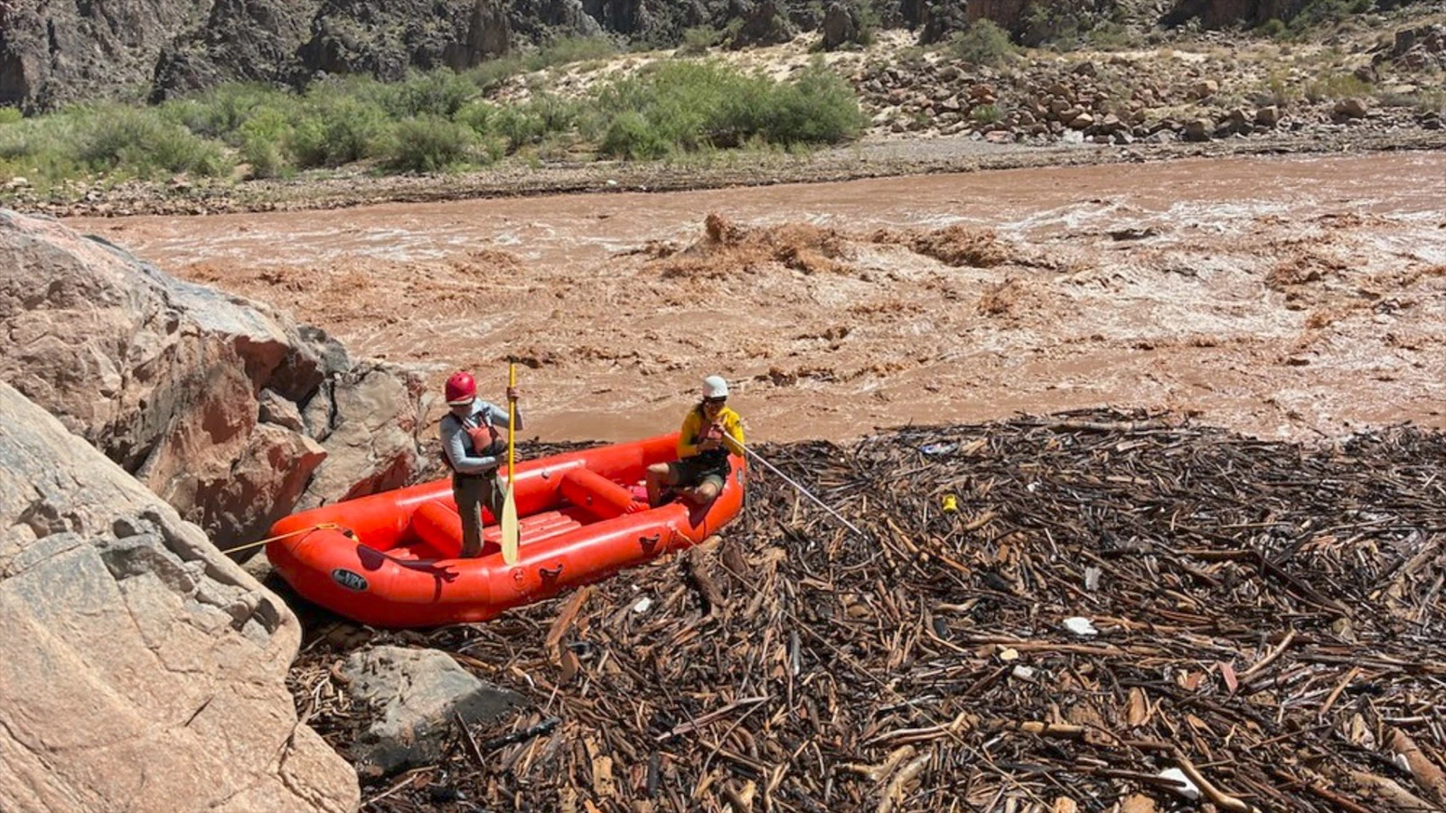 Two rescuers in a raft conduct search operations in a debris pile along the Colorado River near Phantom Ranch earlier this week.