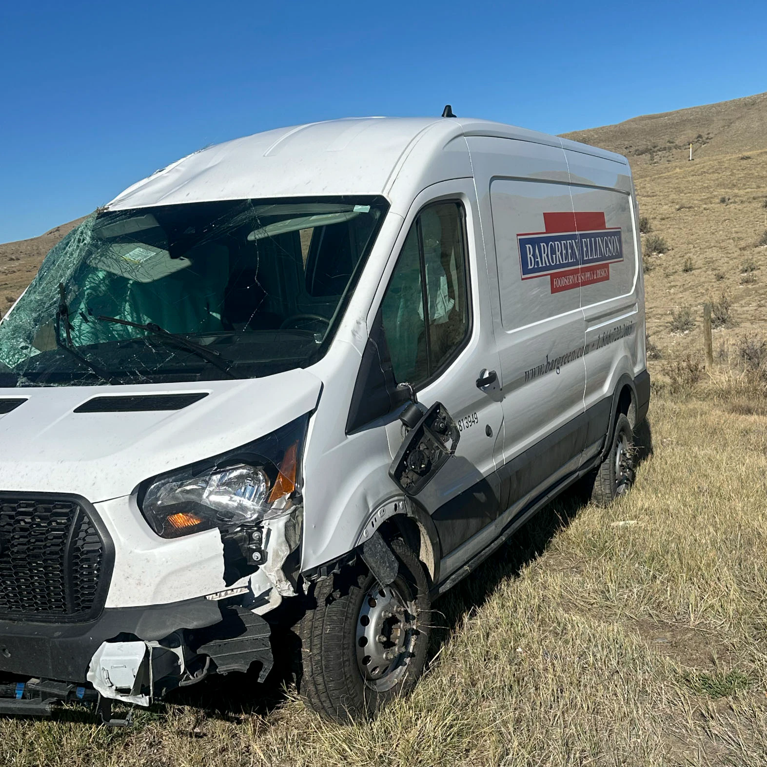 The Bargreen Ellingson delivery van sits heavily damaged after rolling along Interstate 25 north of Casper on Friday.