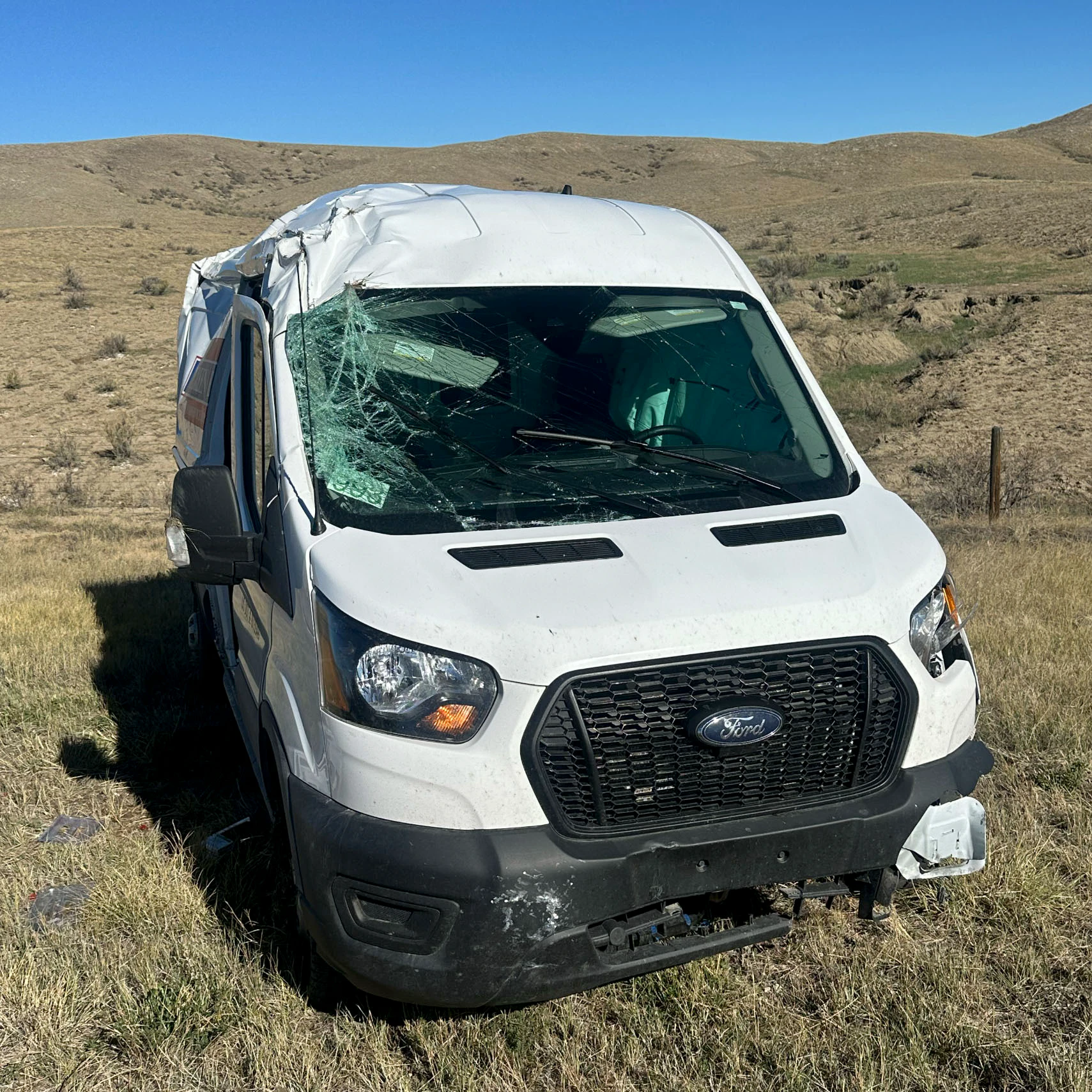 The Bargreen Ellingson delivery van sits heavily damaged after rolling along Interstate 25 north of Casper on Friday.
