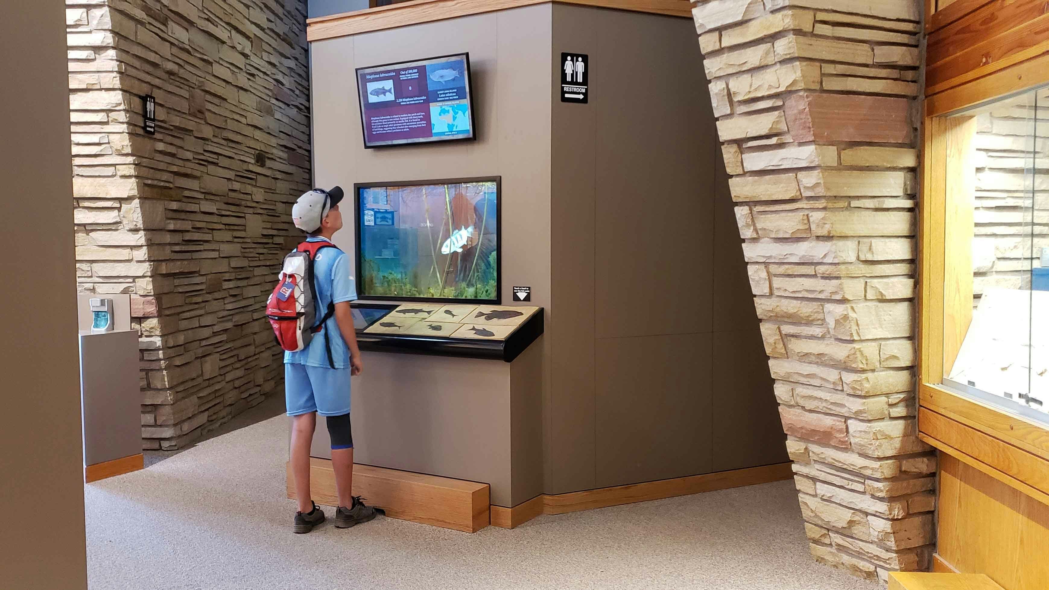 A French boy traveling with his father, watches fossil fish come back to life thanks to a virtual reality display. Chouvet's father is a French tour guide, surveying travel opportunities to share with his clients