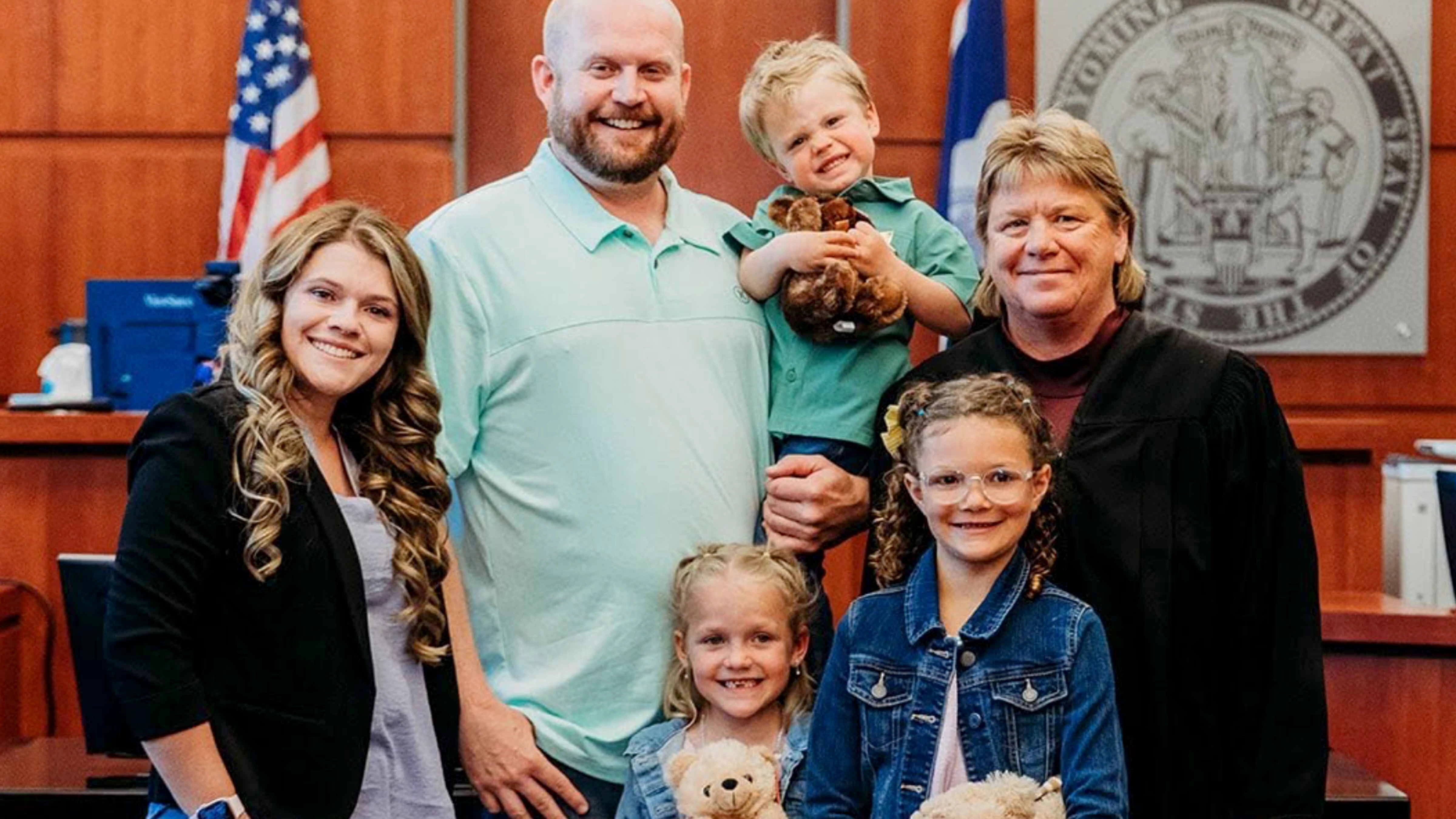 Ashley Monroe, left, and her family pose with Natrona County Circuit Court Judge Kerri Johnson after an adoption.