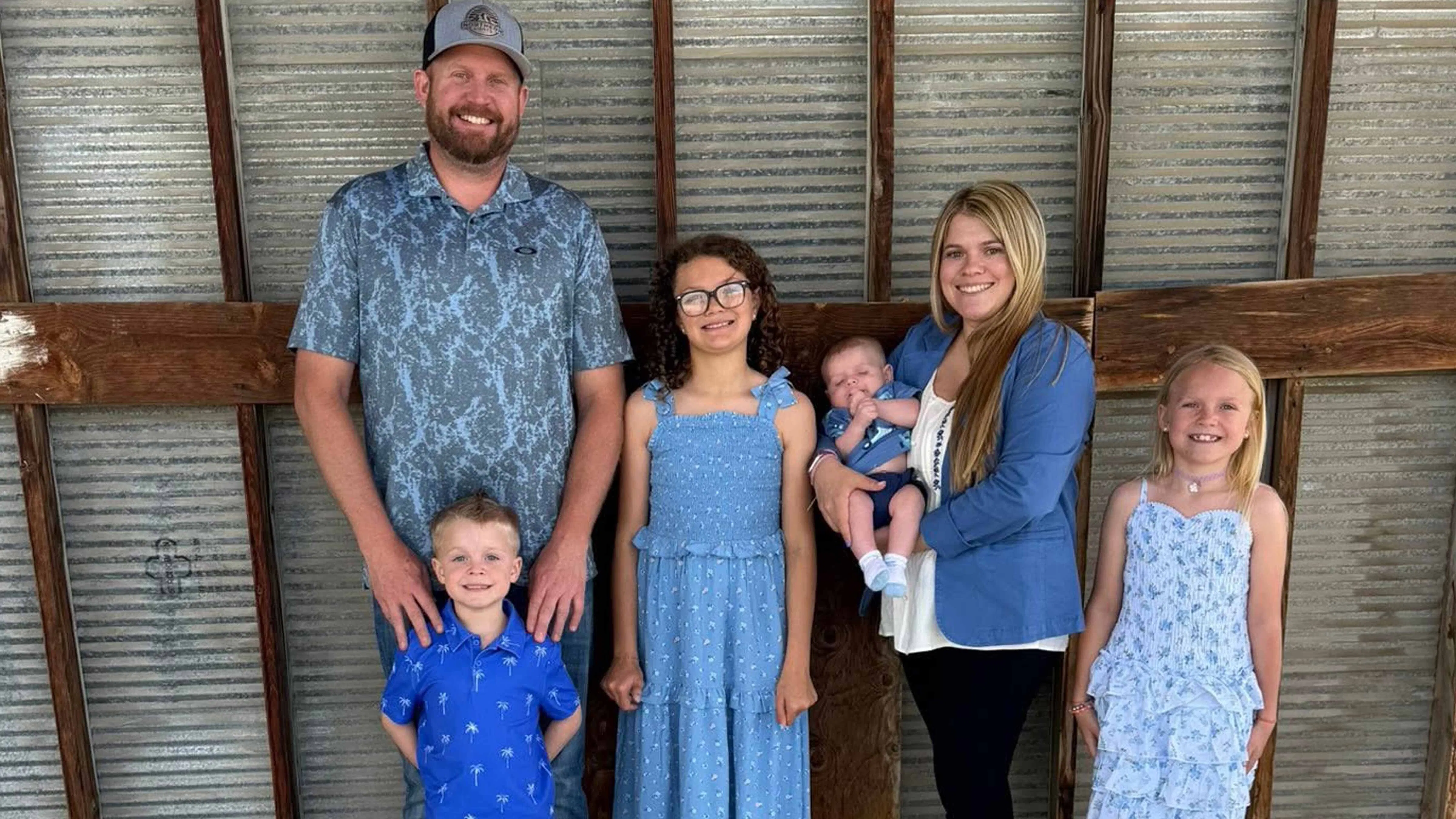 Ashley and Ian Monroe with their children in a family portrait. Monroe said the alleged stalking campaign targeted not only her but also her husband and mother, prompting the family to change how they lived day to day.
