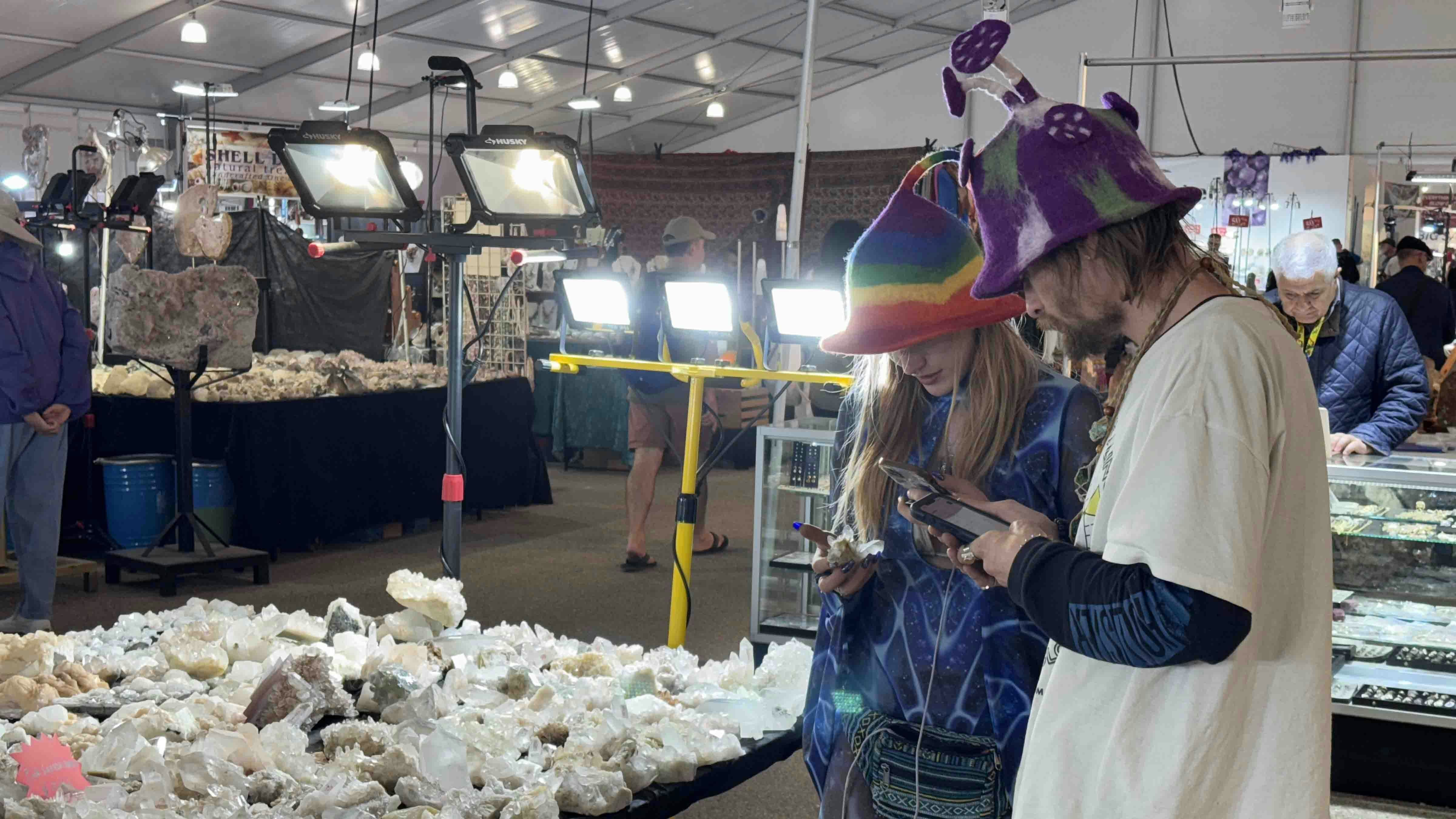 Buyers look into acquiring a few mineral slabs at the 22nd Street Mineral, Fossil, and Gem Show during the 2025 Tucson Gem and Mineral Show.