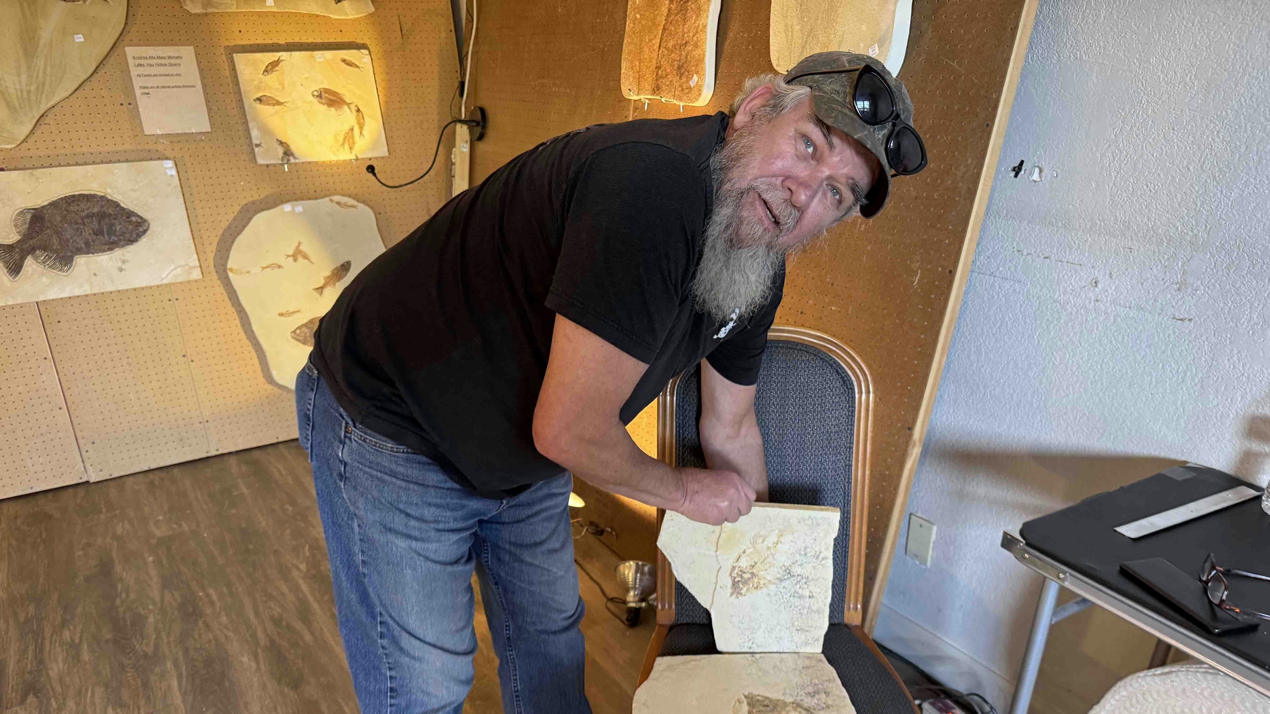 Terry Rickers shows how slabs of rock from the Green River Formation near Kemmerer reveal their fossils. Several specimens like this were displayed in the Dempsey Ridge Room at the Days Inn in Tuscon during the 2025 Tucson Gem and Mineral Show.