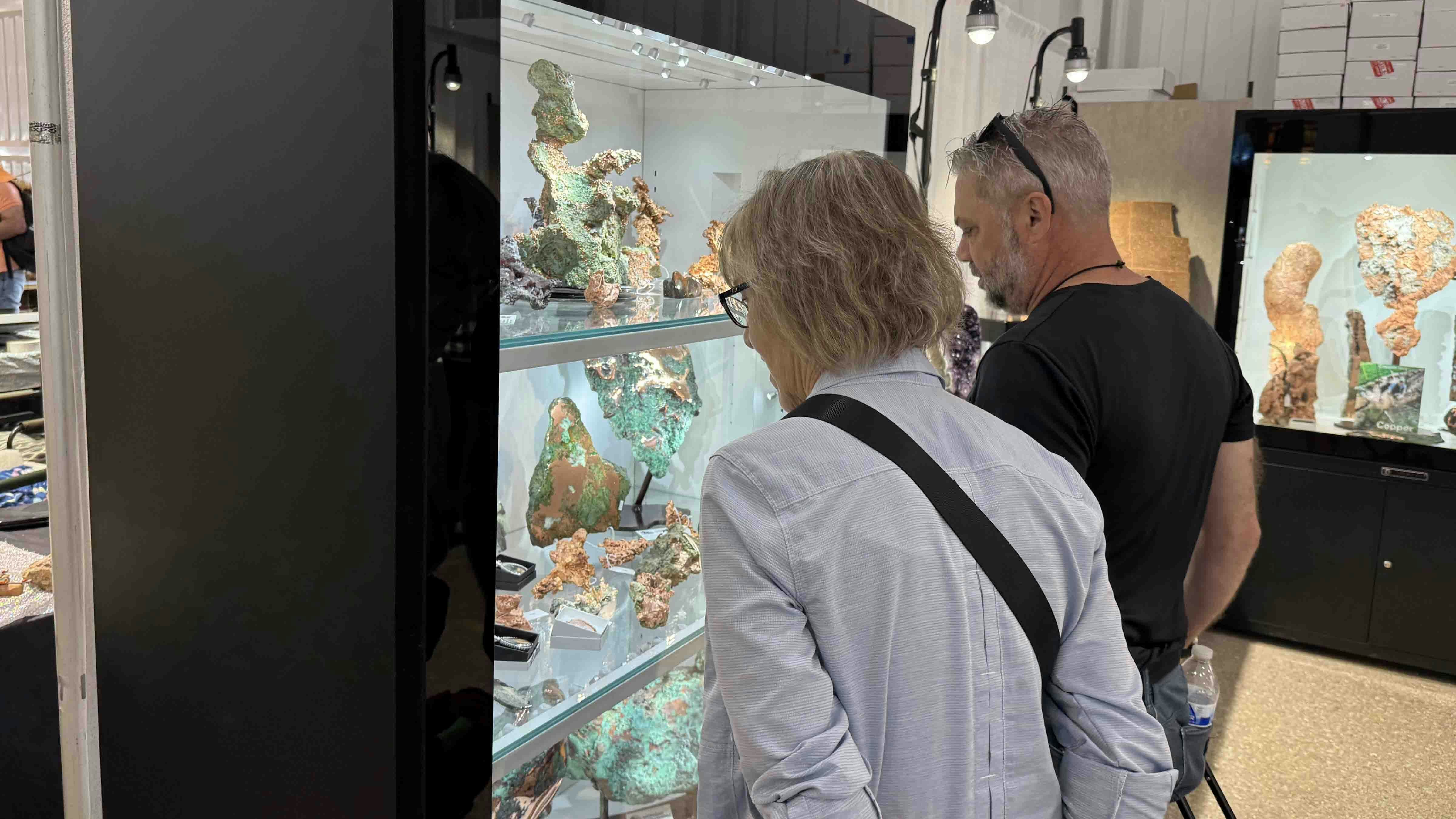 Spectators admire pieces of native copper from Michigan at the 2025 Tucson Gem and Mineral Show.