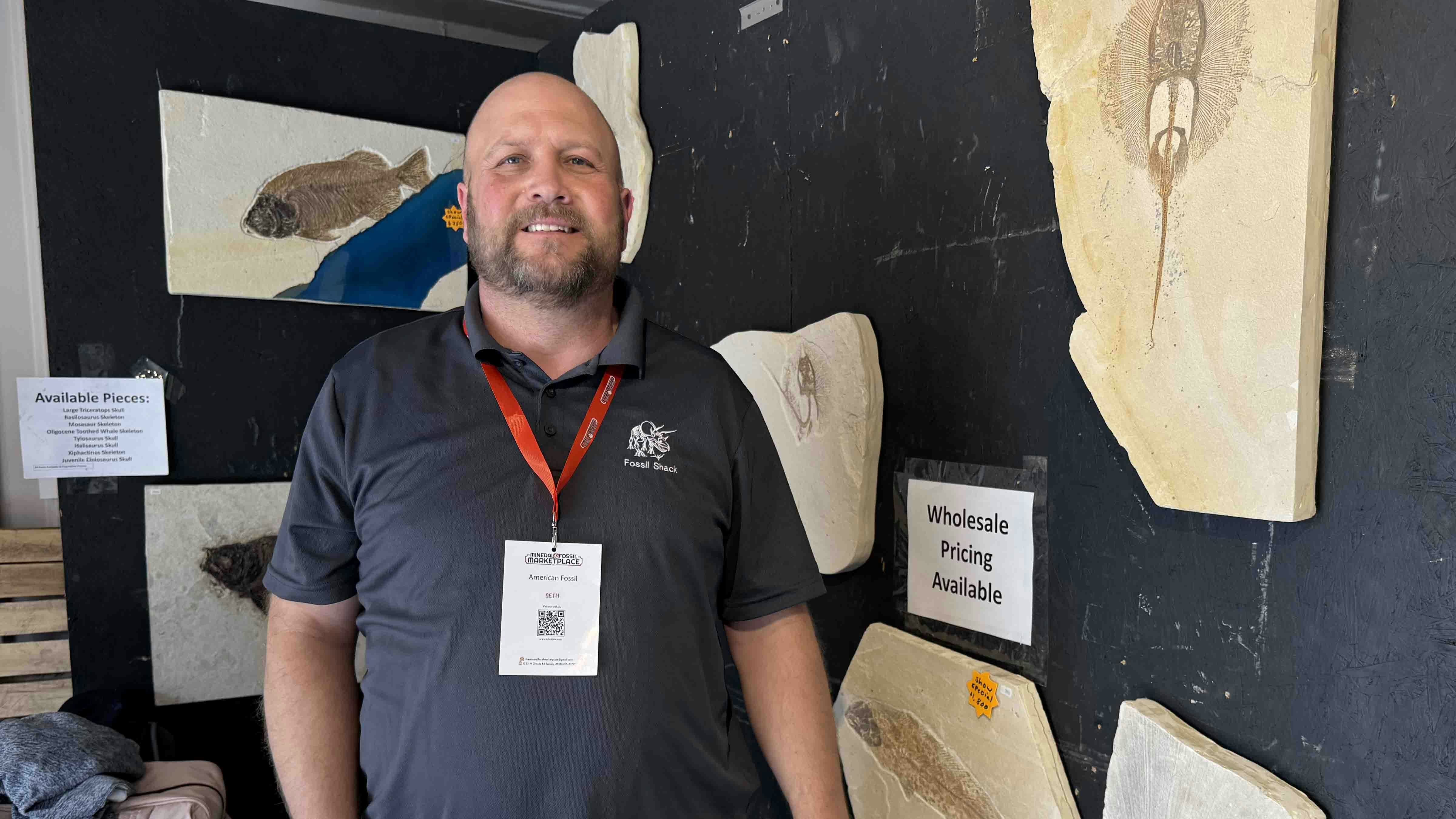 Seth Sorensen inside The Fossil Shack booth at the 2025 Tucson Gem and Mineral Show. Sorensen brings thousands of fossils to Tucson every year and sells nearly all of them, earning enough overhead to keep excavating more and bring them to next year's show.