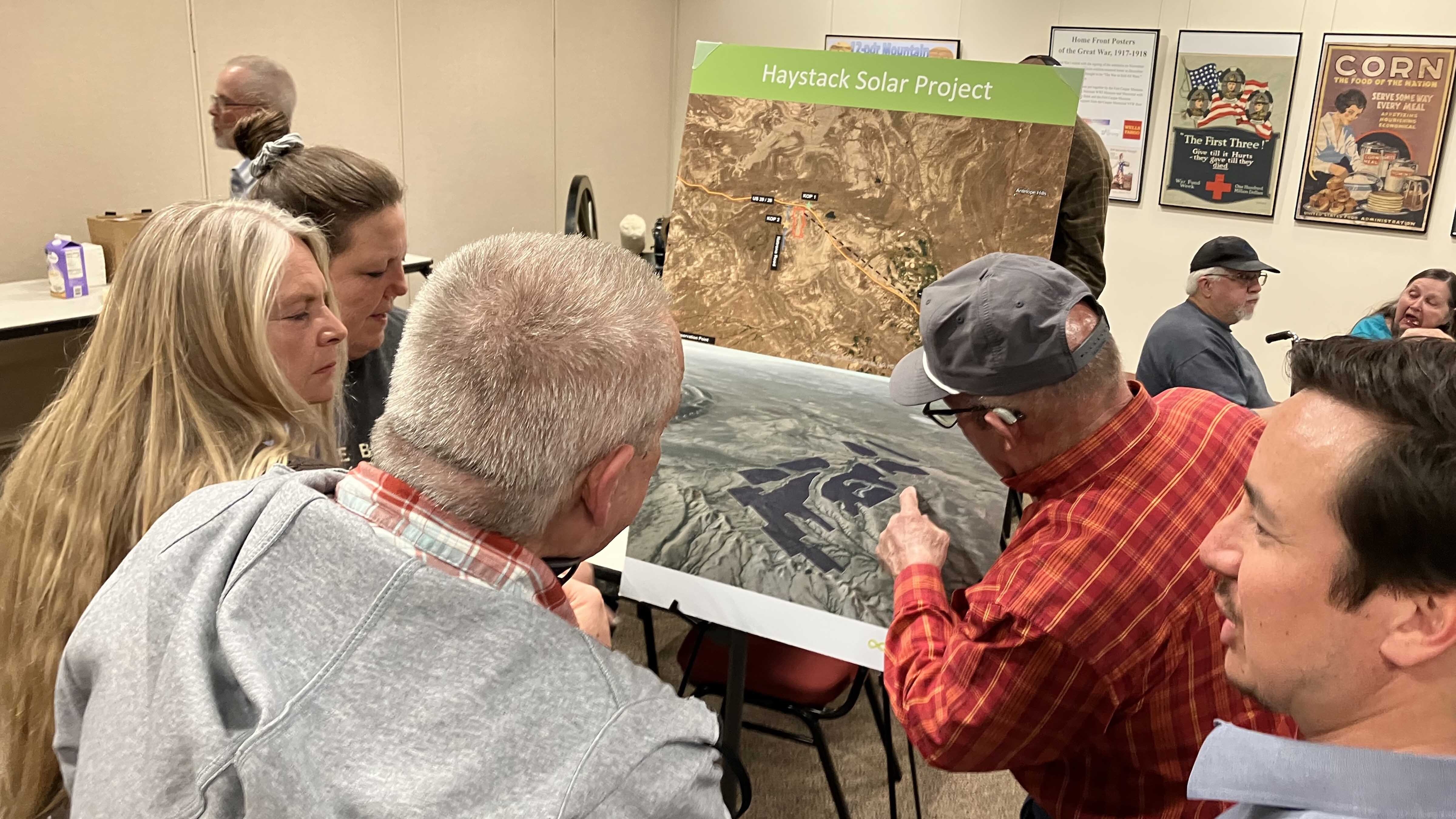 Residents look at the layout of the Haystack Solar project.