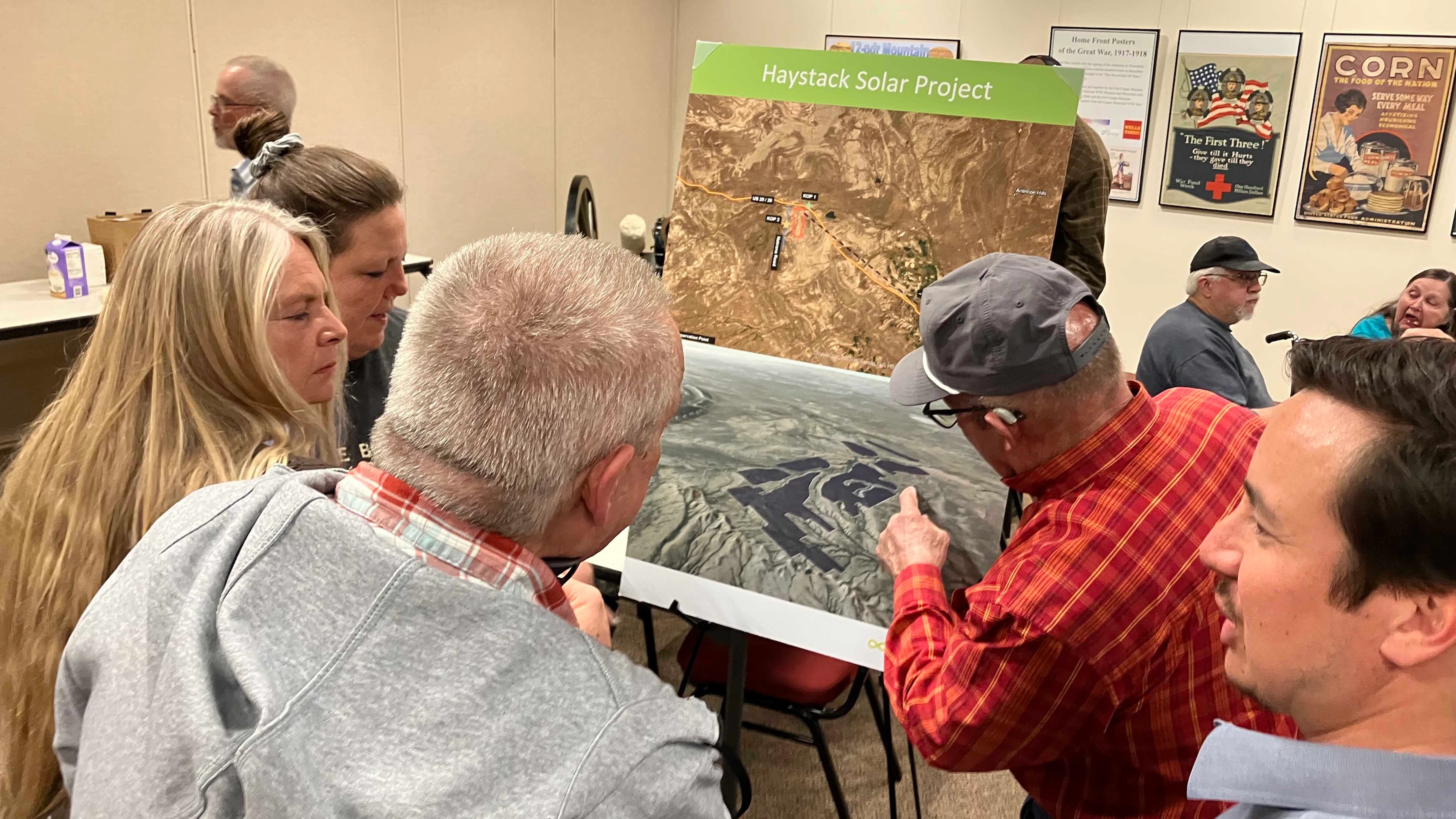 Residents look at the layout of the Haystack Solar project.