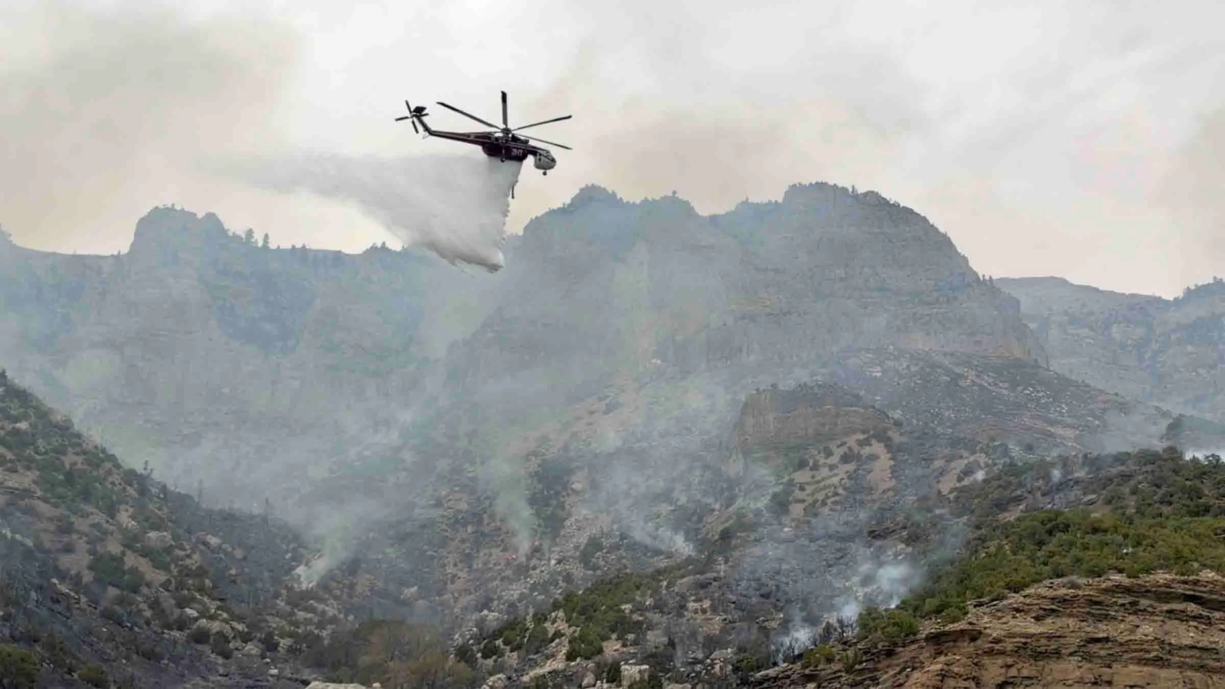 Helicopter dropping water on the Wind River Canyon fire on Saturday, May 16, 2026 (Jackie Dorothy, Cowboy State Daily)