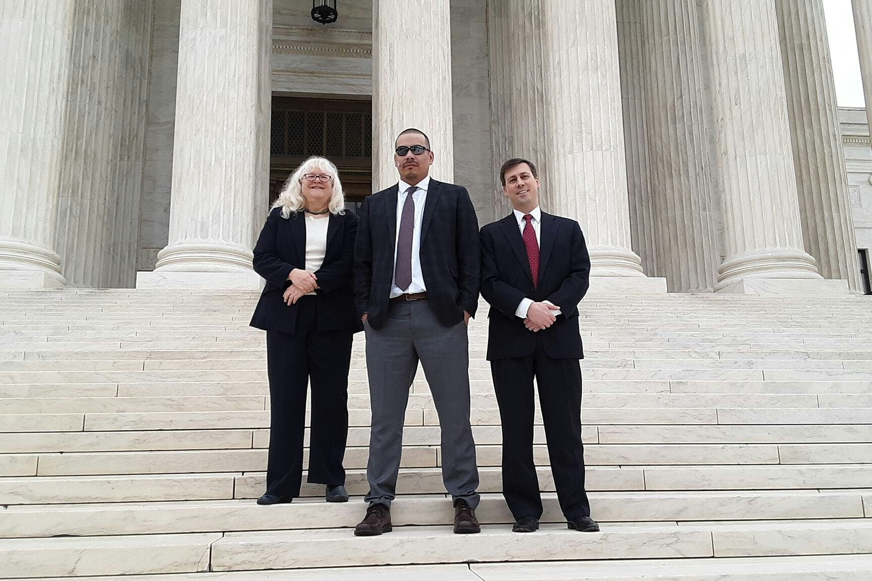 Clayvin Herrera, center, took his Indian hunting dispute with Sheridan County, Wyoming, to the U.S. Supreme Court. He's on the court step with his legal team in this file photo.