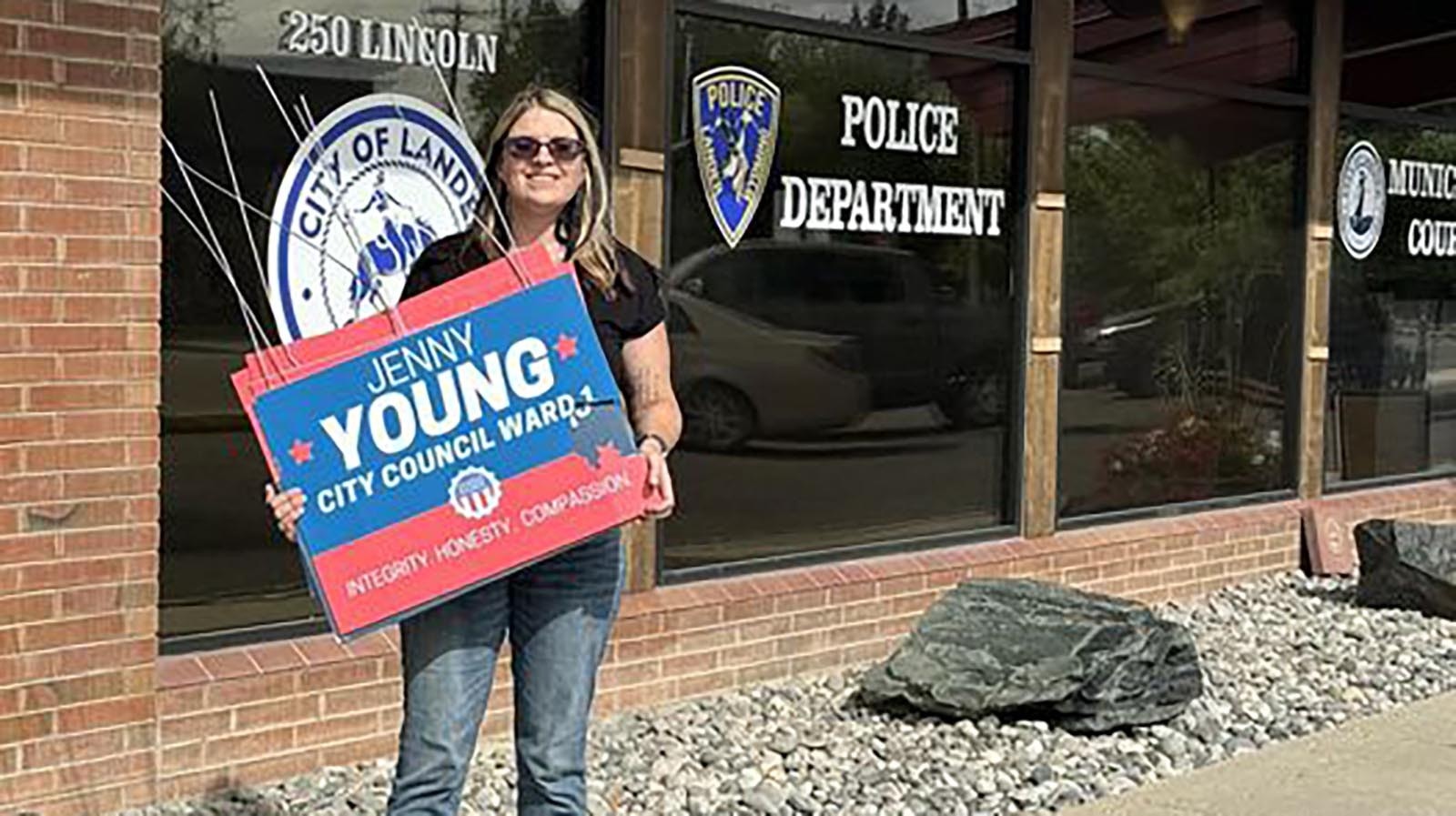 Lander City Council Ward 1 candidate Jenny Young holds some of her signs after recovering them Tuesday with some help from the Lander Police Department.