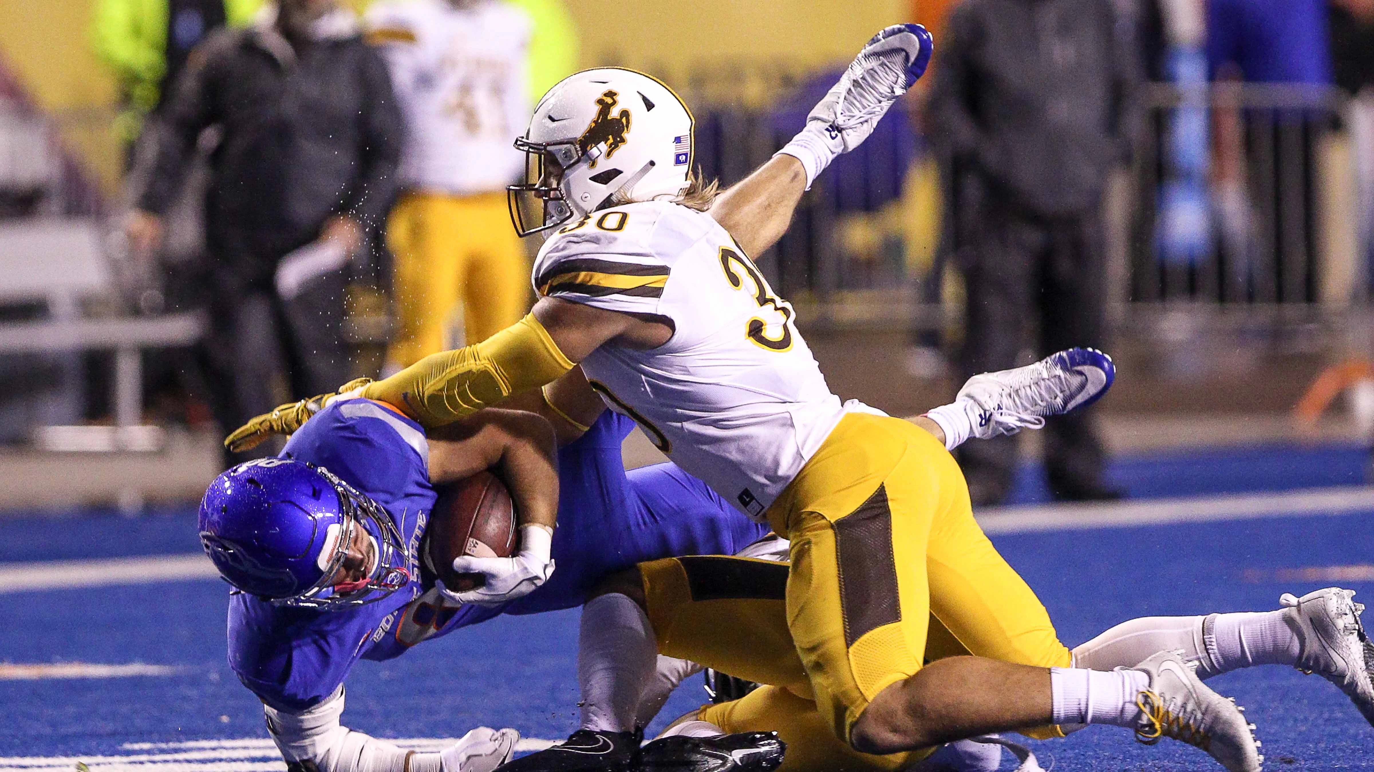 Wide receiver Brock Barr #89 of the Boise State Broncos is tackled by linebacker Logan Wilson #30 of the Wyoming Cowboys during second half action on October 21, 2017 at Albertsons Stadium in Boise, Idaho.