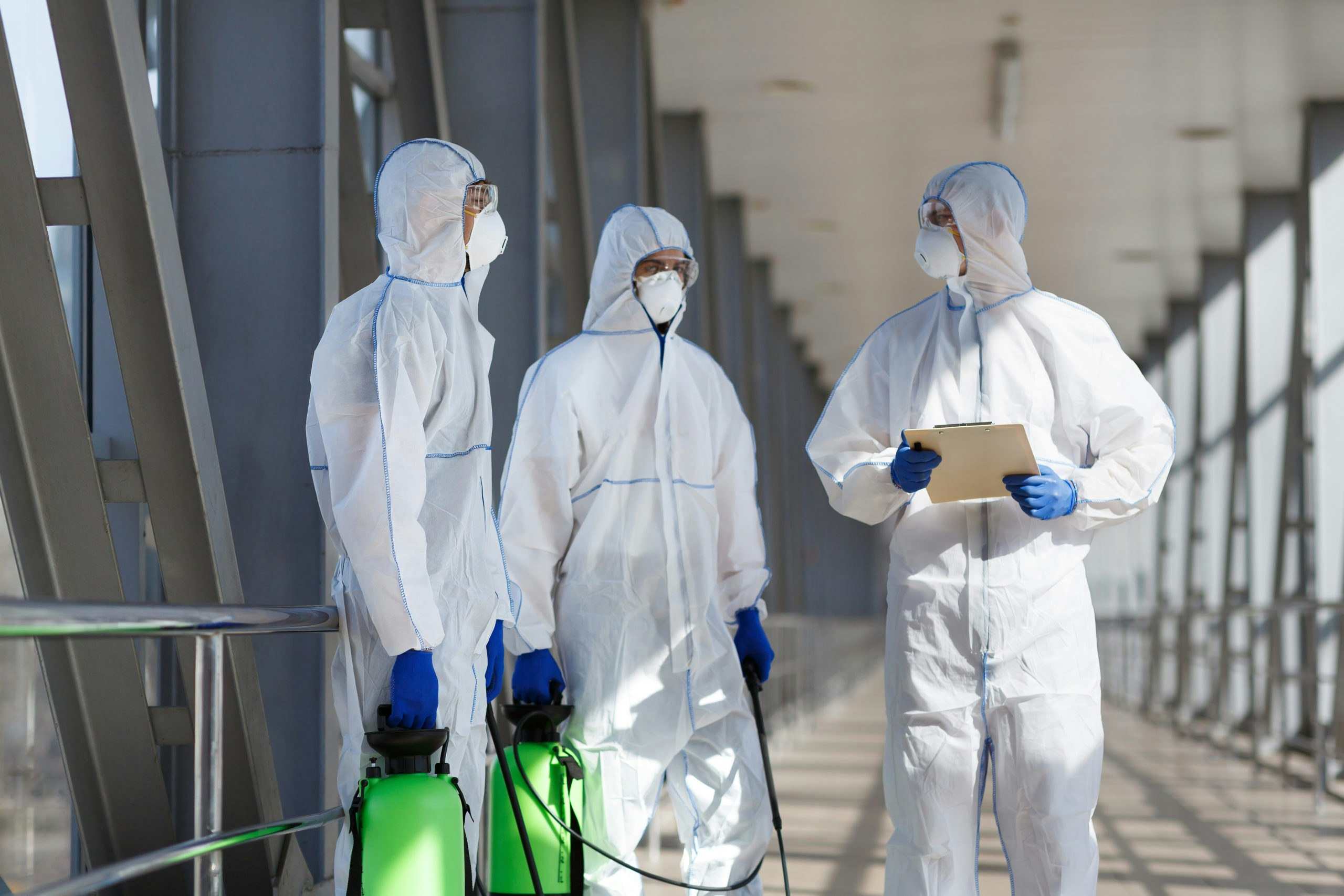 Men in virus protective suits planning to disinfec HV34 QC4 scaled