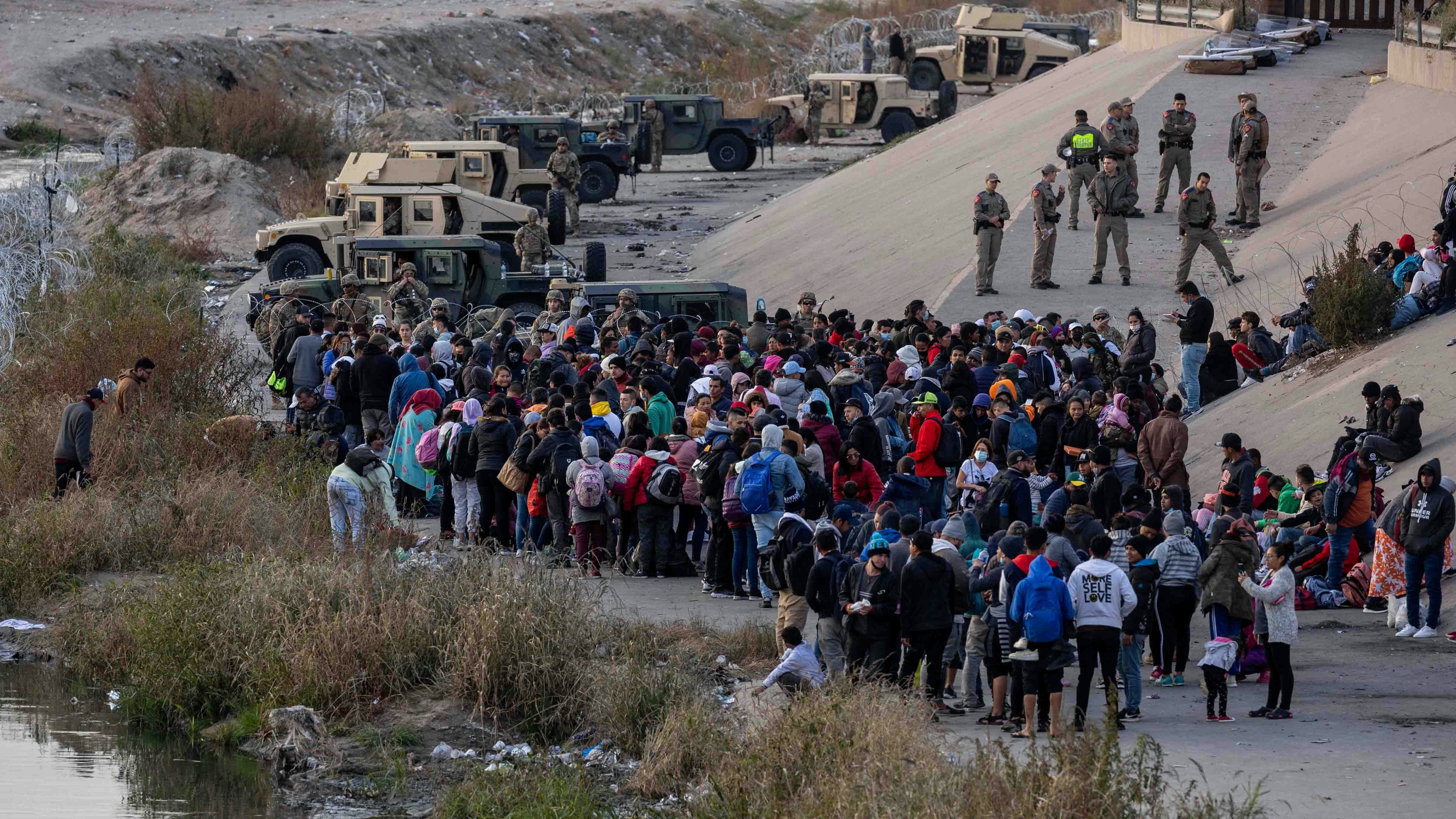 Texas National Guard troops block immigrants from entering a high-traffic border crossing area along Rio Grande in El Paso, Texas