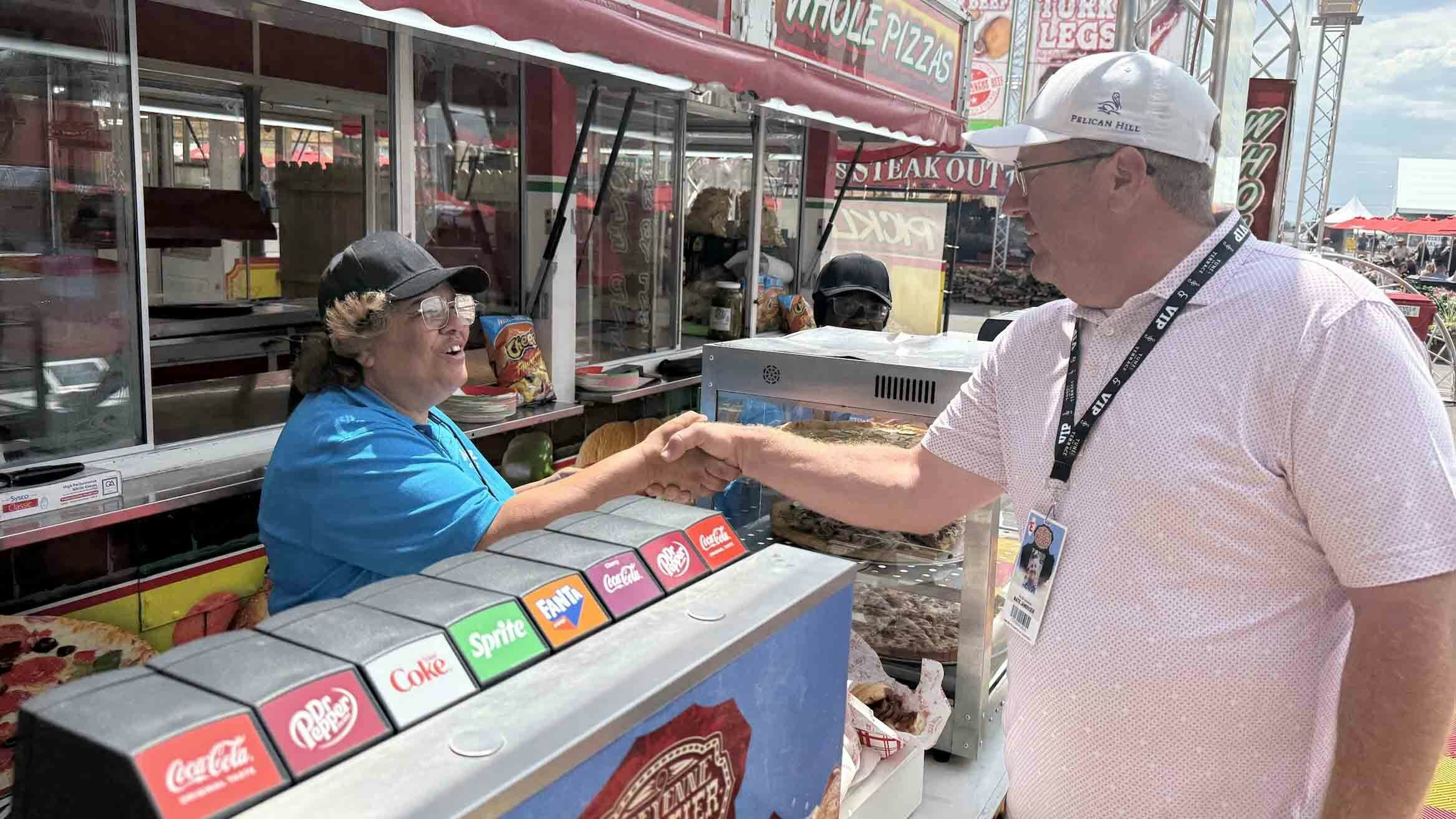 Everyone knows Nate. Nate Janousek chats with one of the food employees at Cheyenne Frontier Days