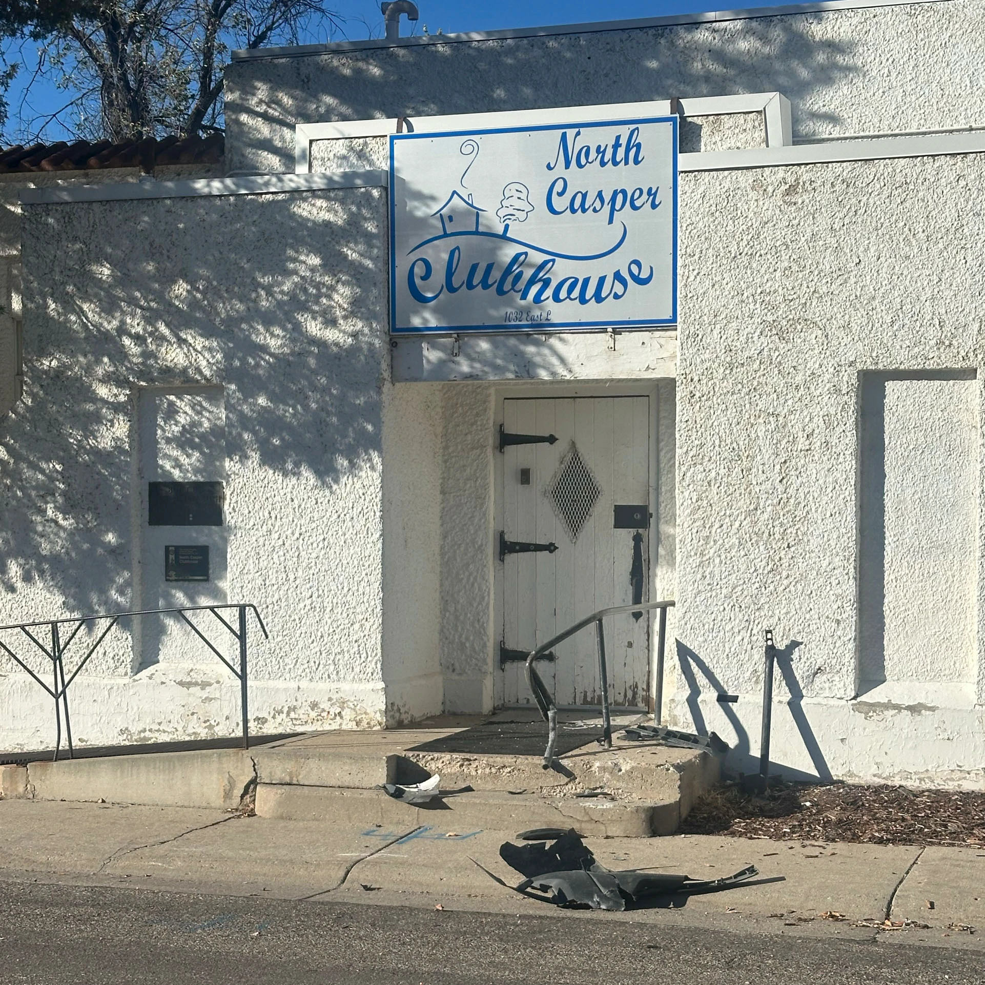Broken vehicle pieces litter the sidewalk outside the North Casper Clubhouse after the stolen Bargreen Ellingson delivery van struck the building Friday, according to company employees. A railing near the entrance also appears bent and damaged.