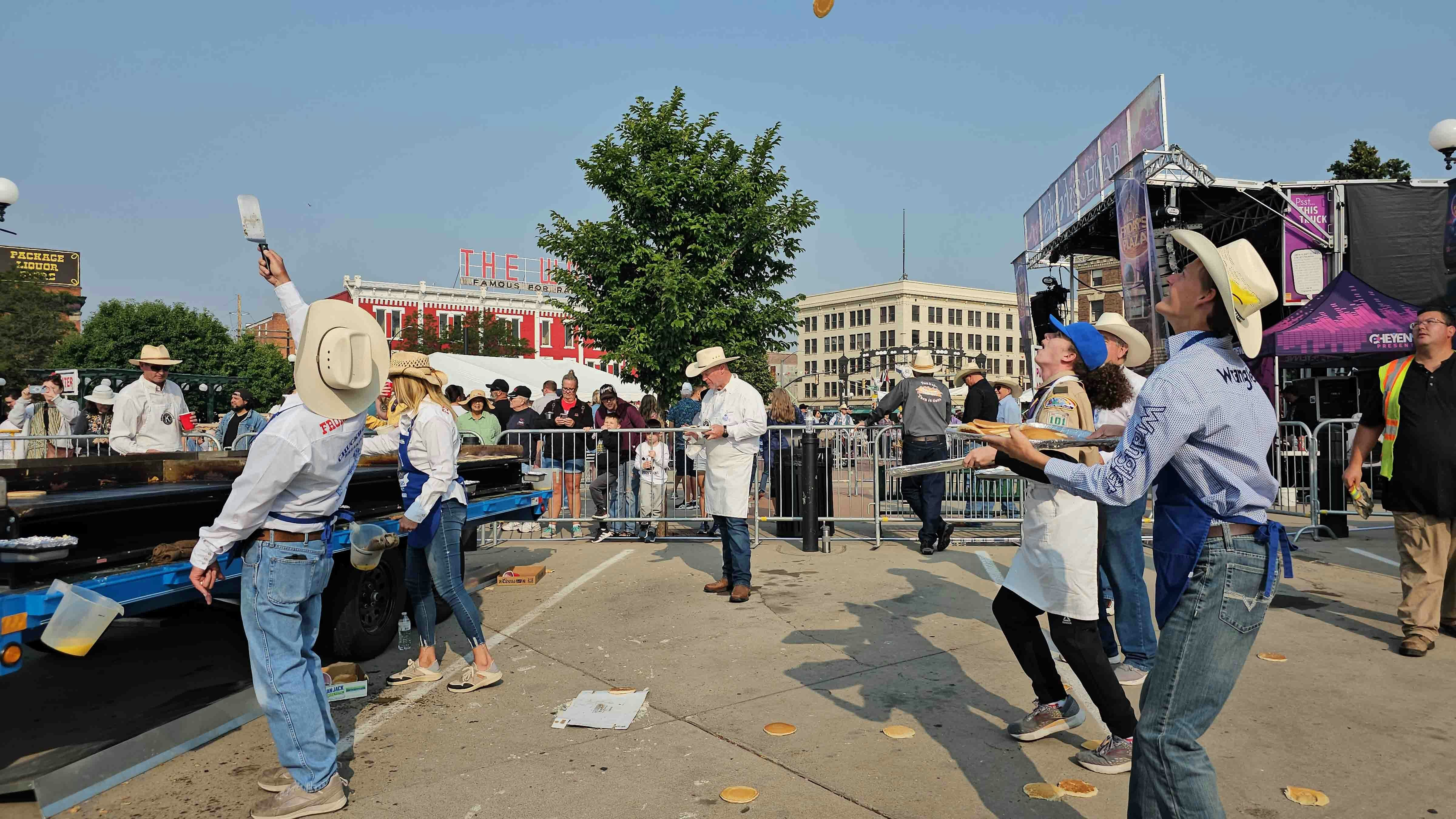 Volunteers have to be nimble sometimes to catch the pancakes as they're flipped off the griddle.