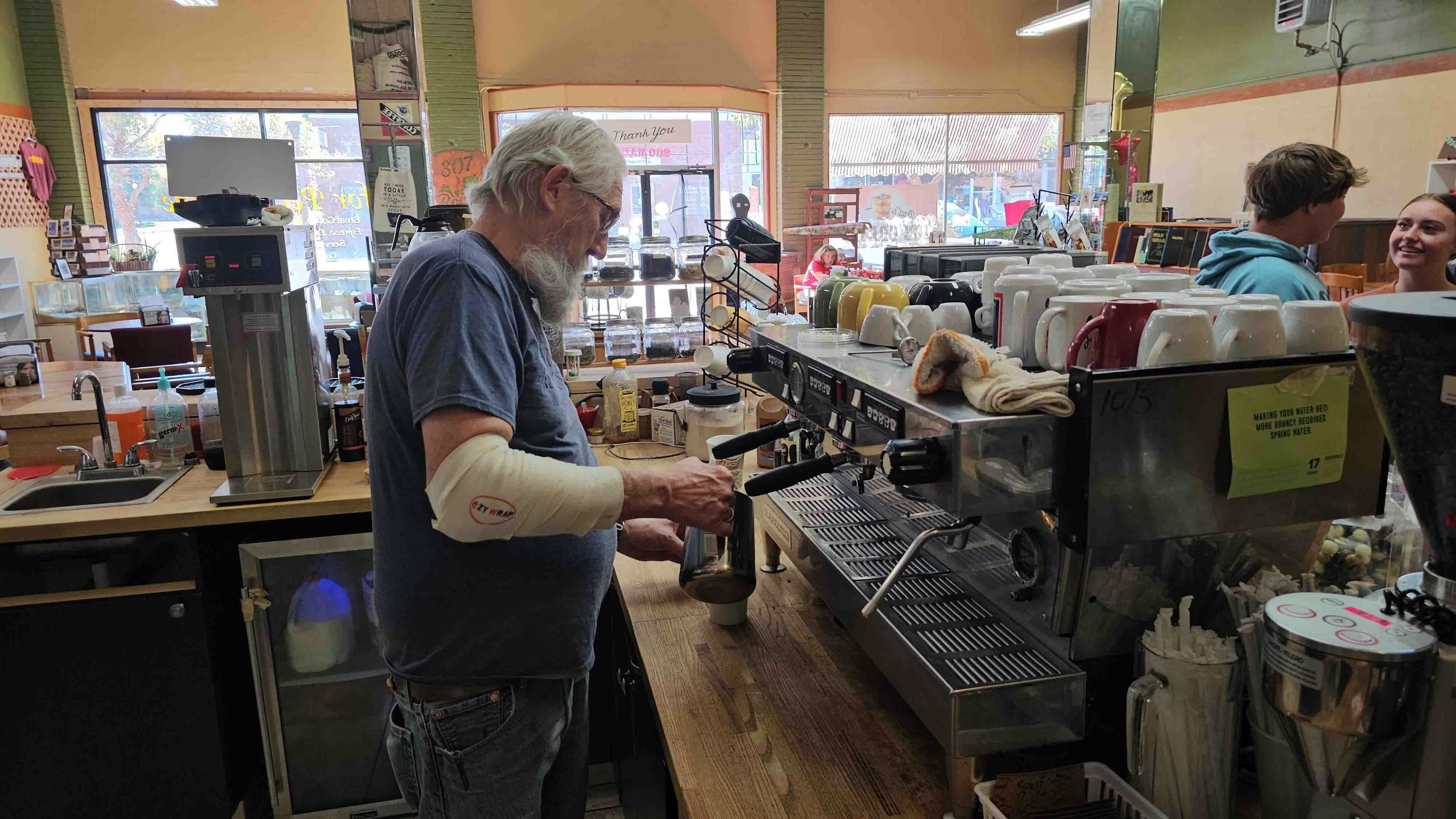 Pete Bass makes a latte at For Pete's Sake, a coffee shop in Evanston.