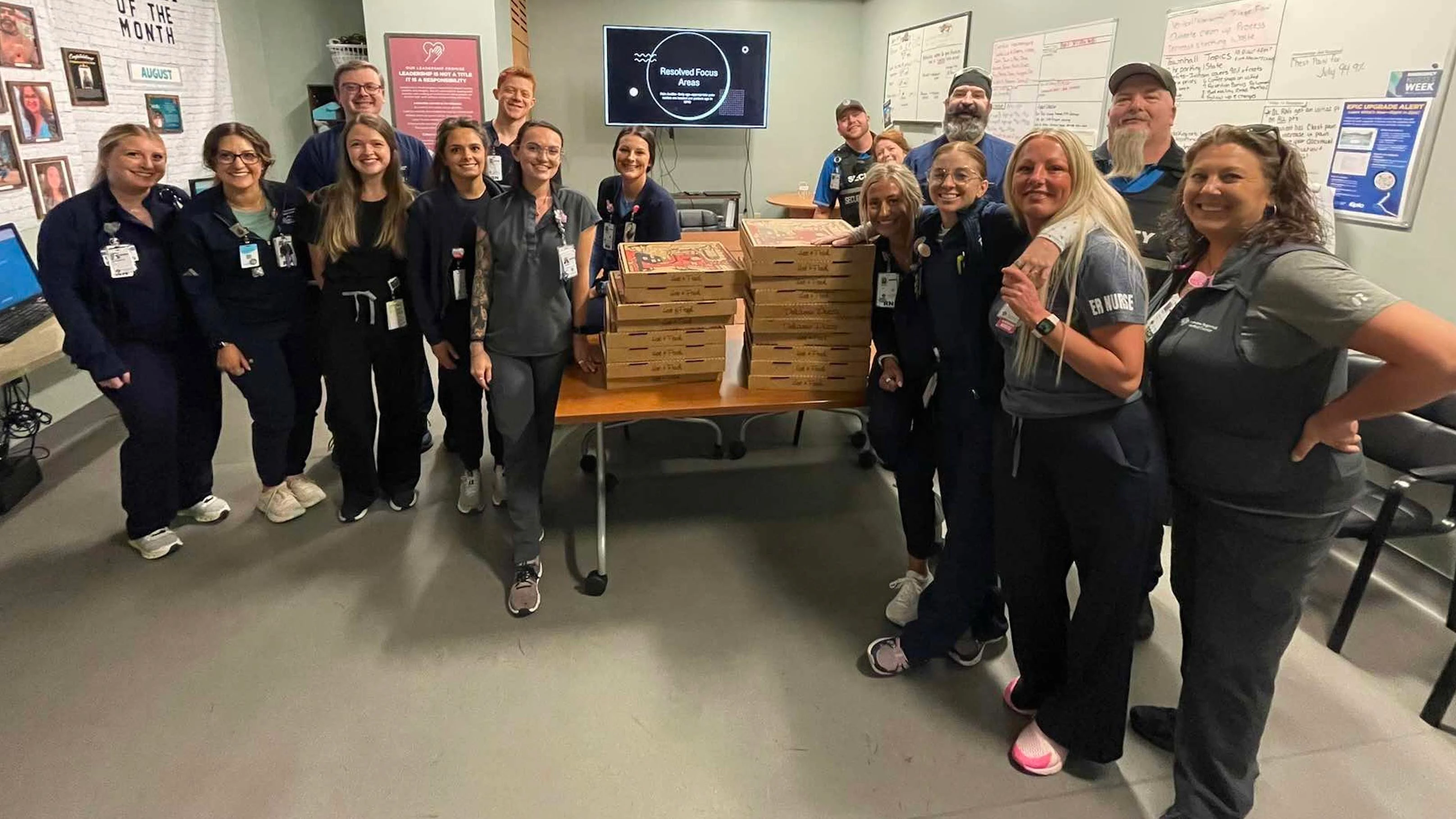 Cheyenne Regional Medical Center ER staff pose with 18 pizzas donated by L’Osteria Mondello after a prank order went unclaimed.
