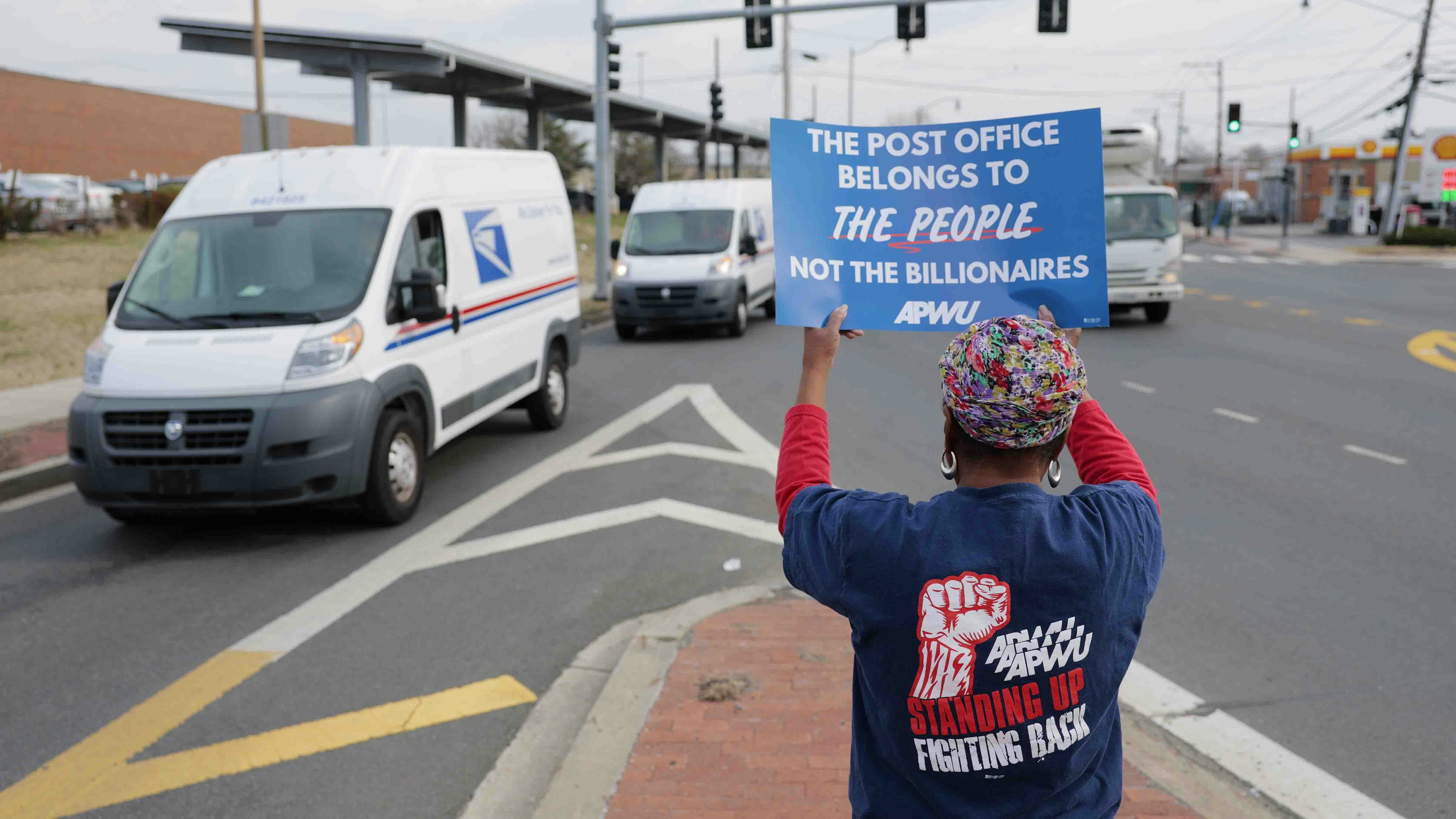 Activists protest during a "U.S. Mail Not For Sale" rally near the Brentwood Post Office on March 20, 2025 in Washington, DC.