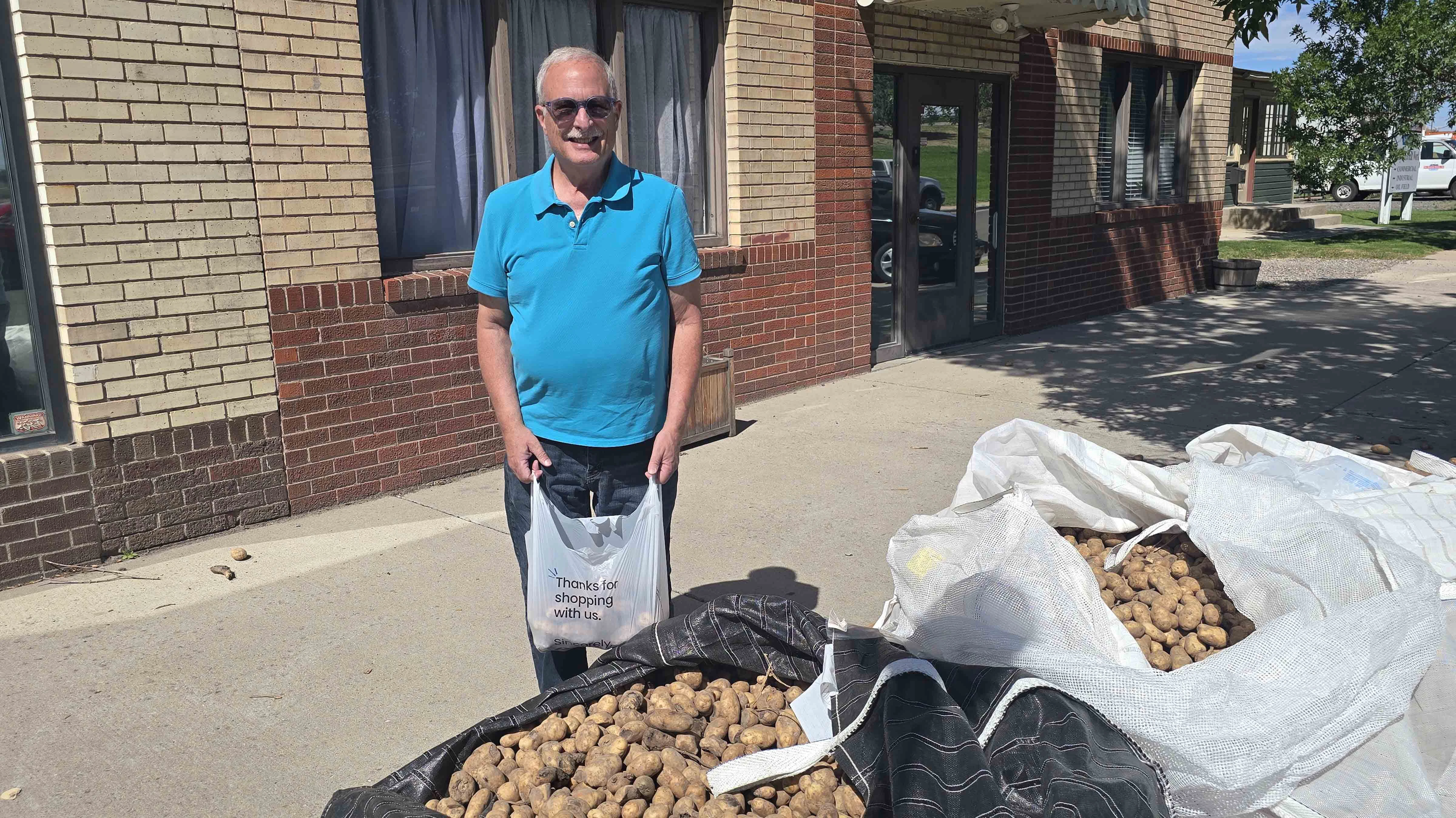 Marlin Casey is taking a bag of free potatoes to a family whose breadwinner was recently injured.