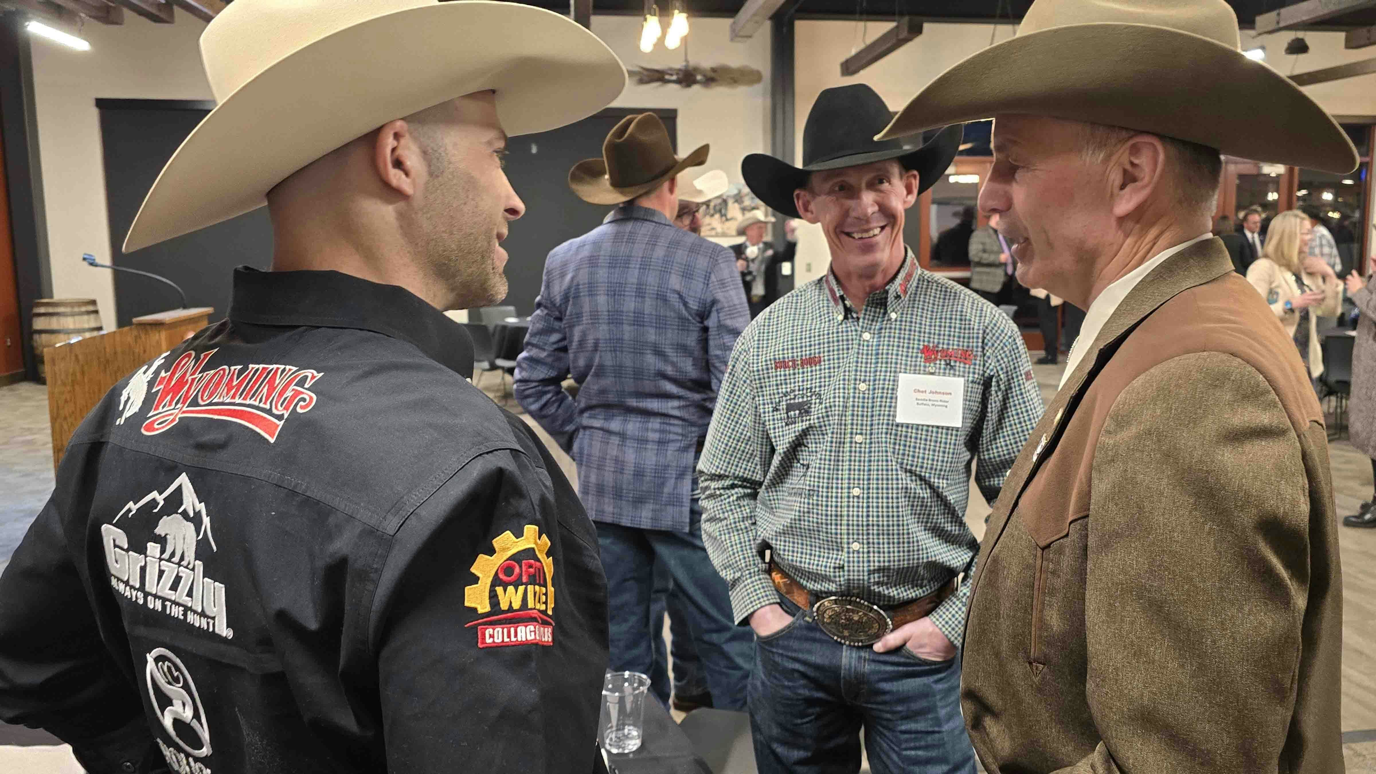 Info Rodeo stars Dusty Tuckness, left, and Chet Johnson, center, talk to Gov. Mark Gordon after a legislative reception hosted by Cheyenne LEADS. The rodeo stars told Cowboy State Daily they were there to support both Wyoming and the PRCA.