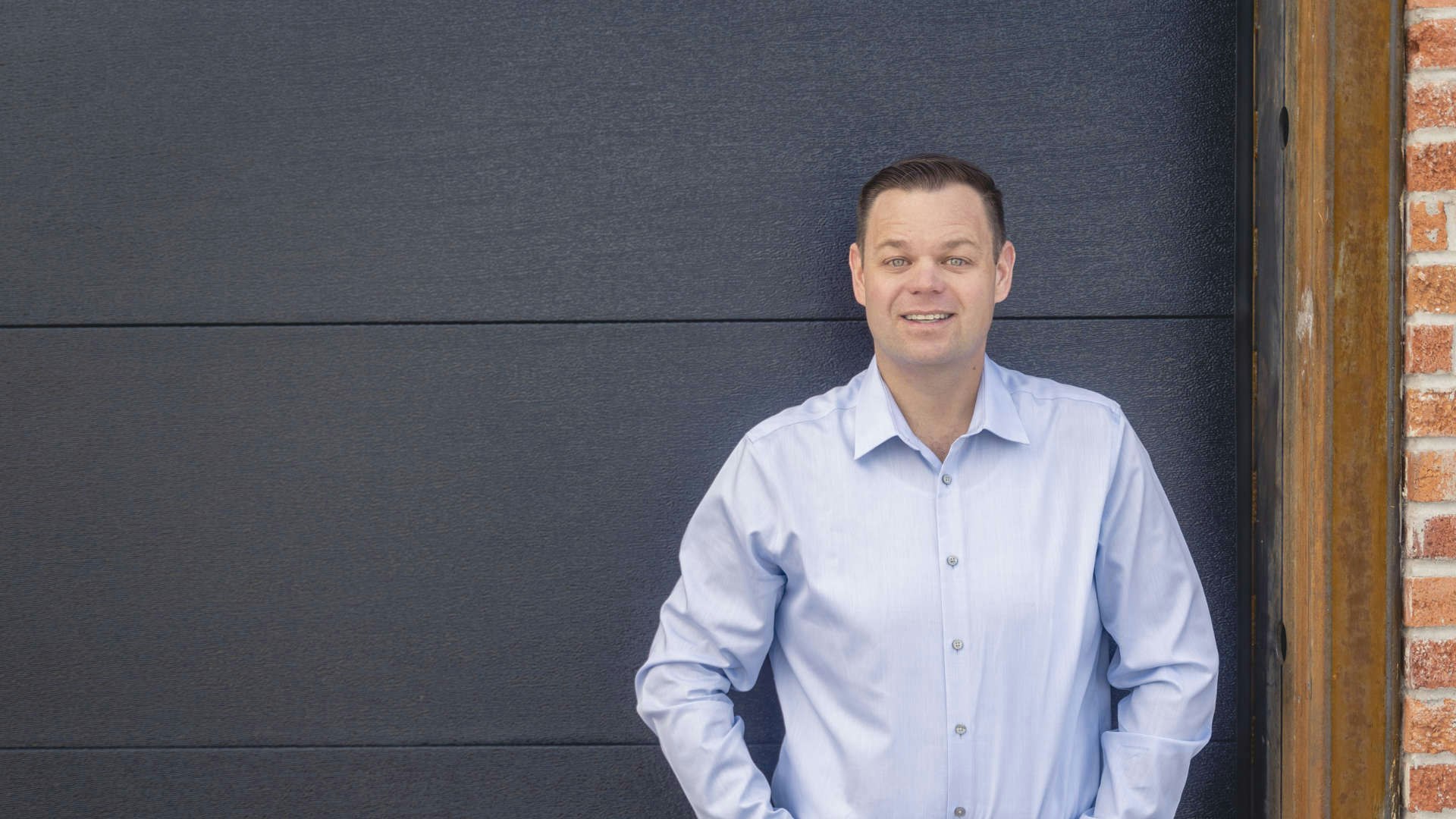 Photo of Reid Rasner standing next to a building.