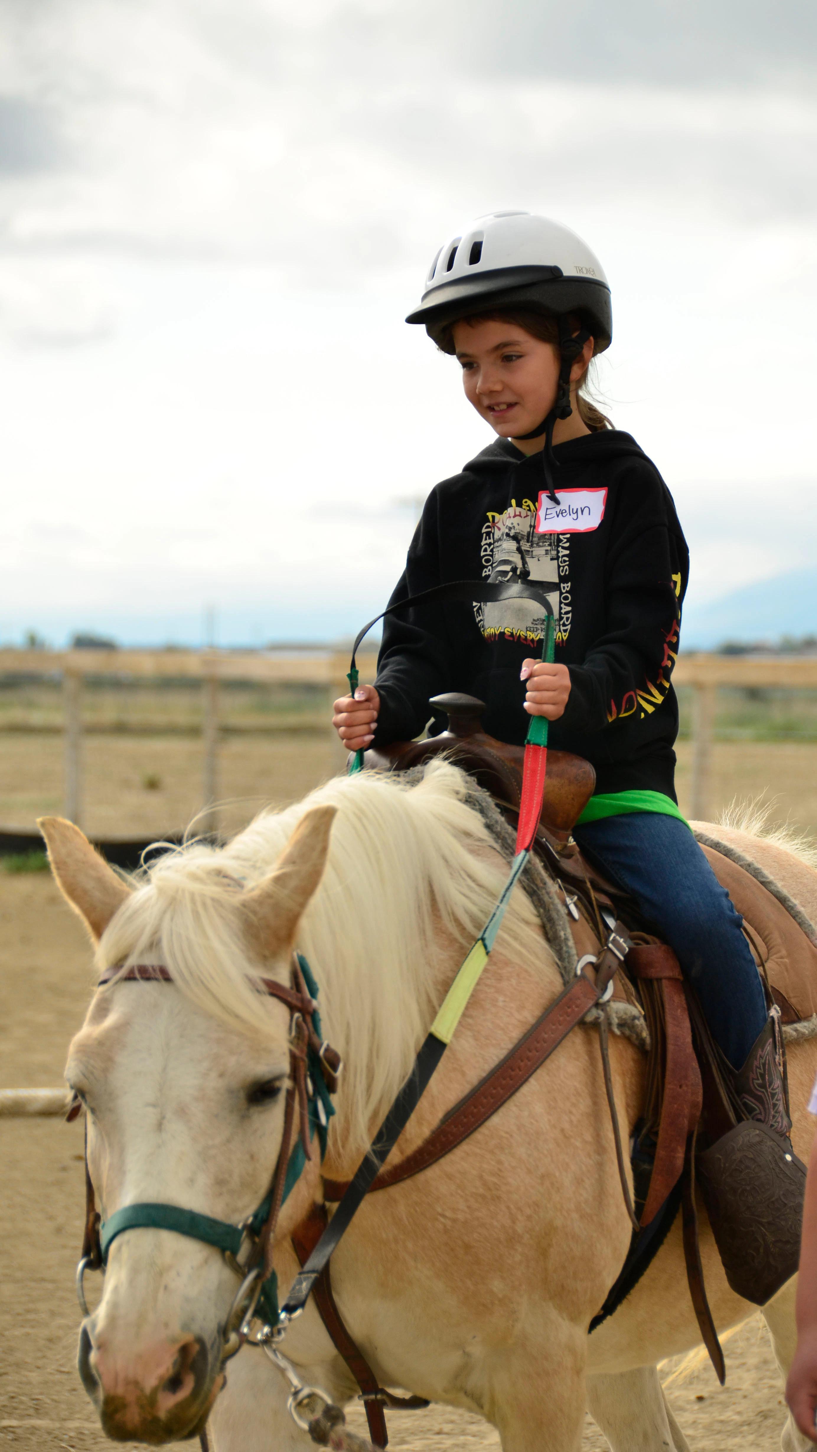 Eight-year-old Evelyn Waller rides a horse at Ropes & Roses grief camp  near Casper