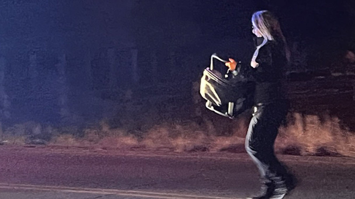 Emergency medical responder carries the baby’s car seat carrier to the ambulance. The baby is safe, Riverton police say