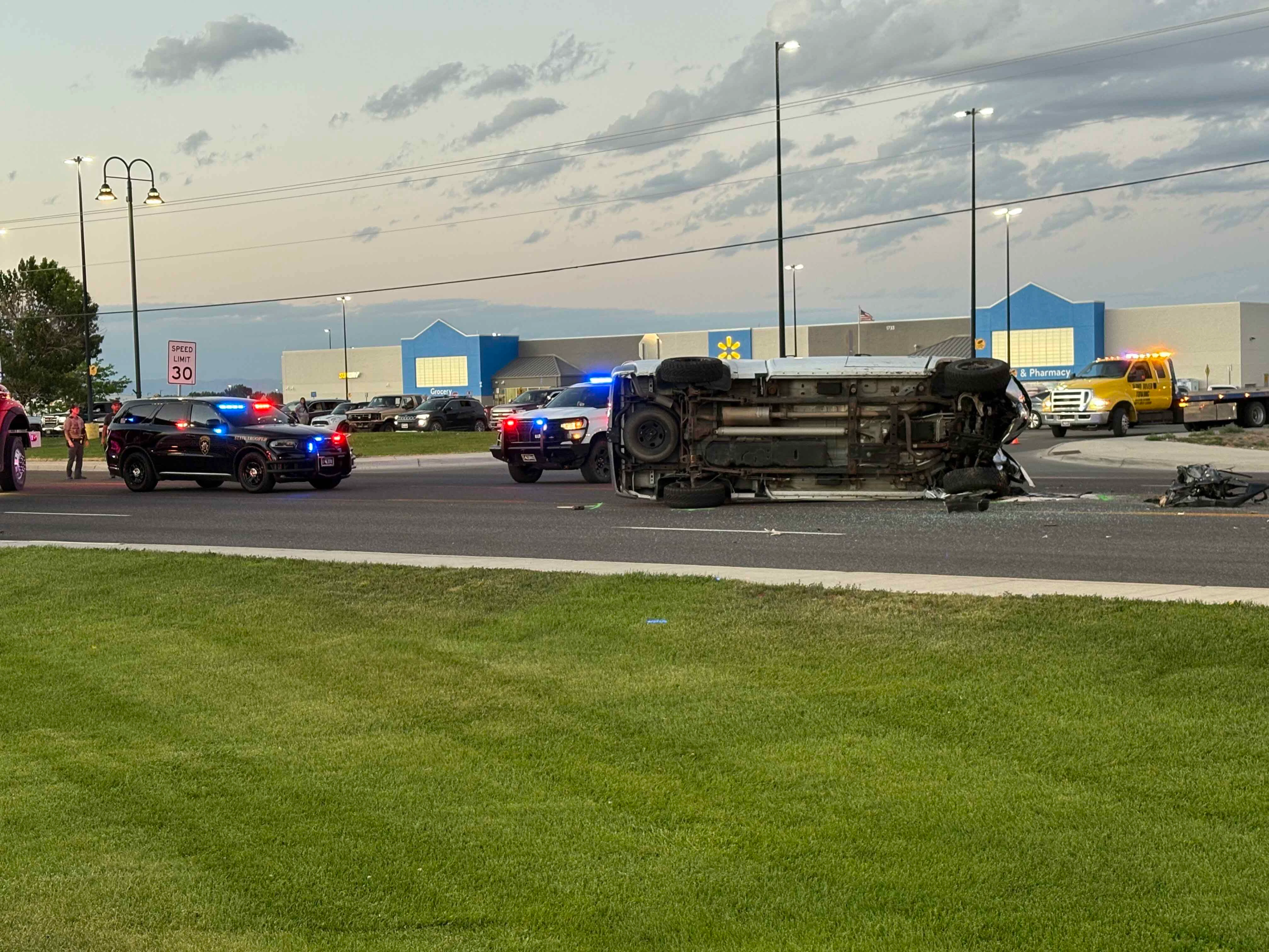 A Dodge pickup involved in a double fatal car crash Wednesday evening lay on its side before wreckers righted it and winched it onto a trailer. The driver of the pickup tried to flee the scene, one witness said