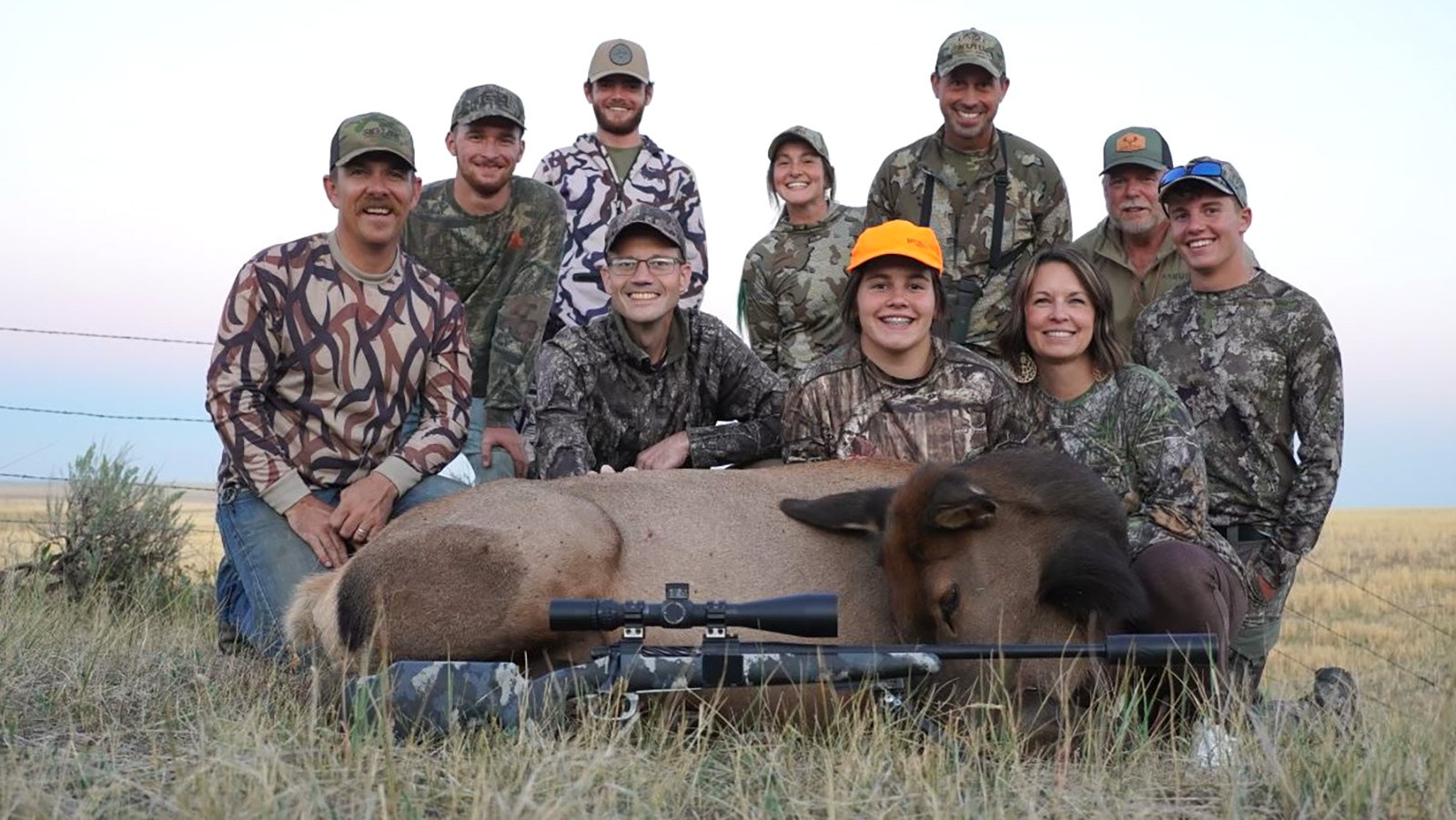 Sadie Swartzfager, 14, of Pennsylvania – in the orange hat – joined family and friends in celebrating getting her first elk in Wyoming.